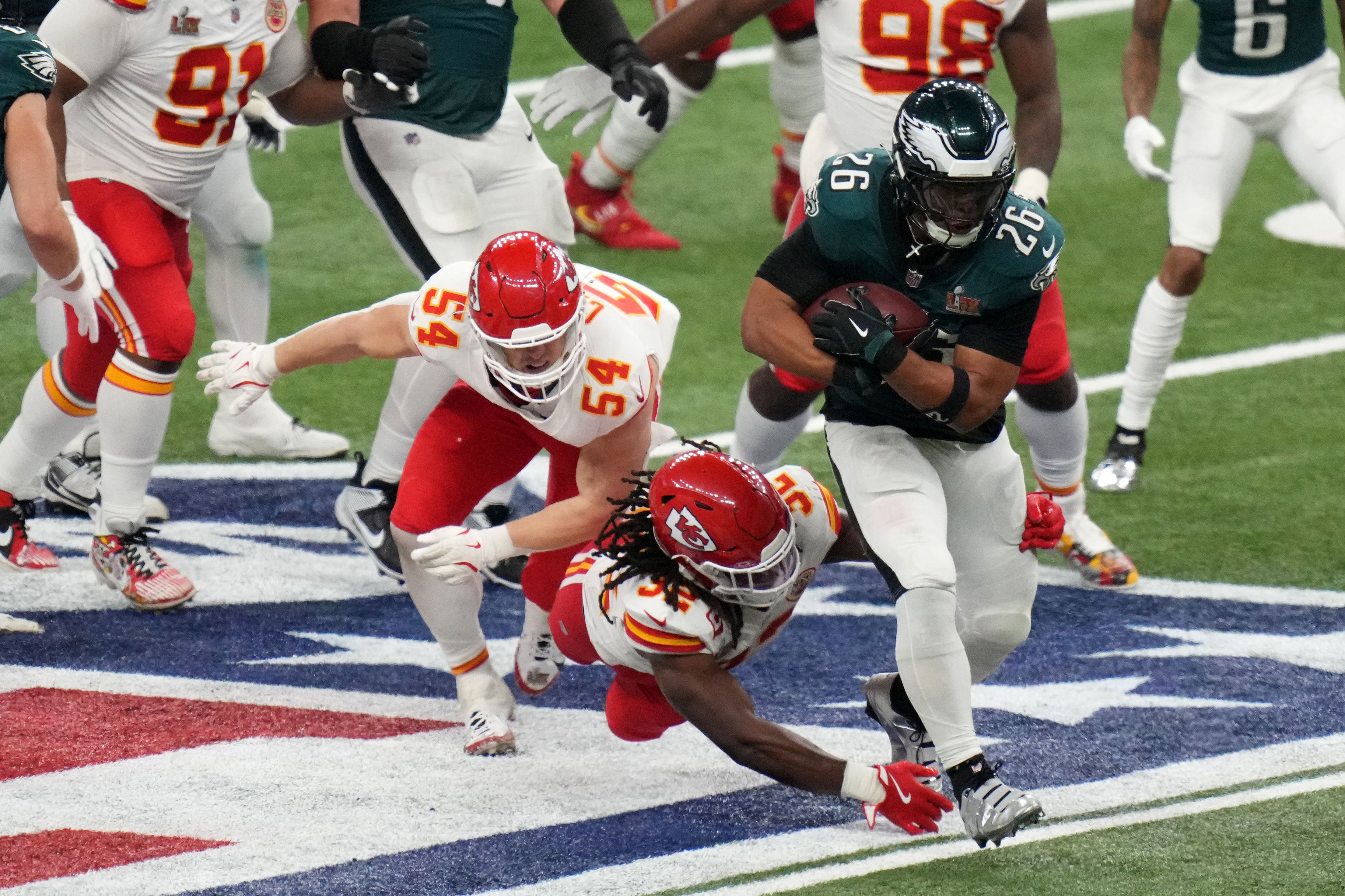 Philadelphia Eagles running back Saquon Barkley (26) rushes the ball against the Kansas City Chiefs during the third quarter in Super Bowl LIX halftime show at Caesars Superdome.