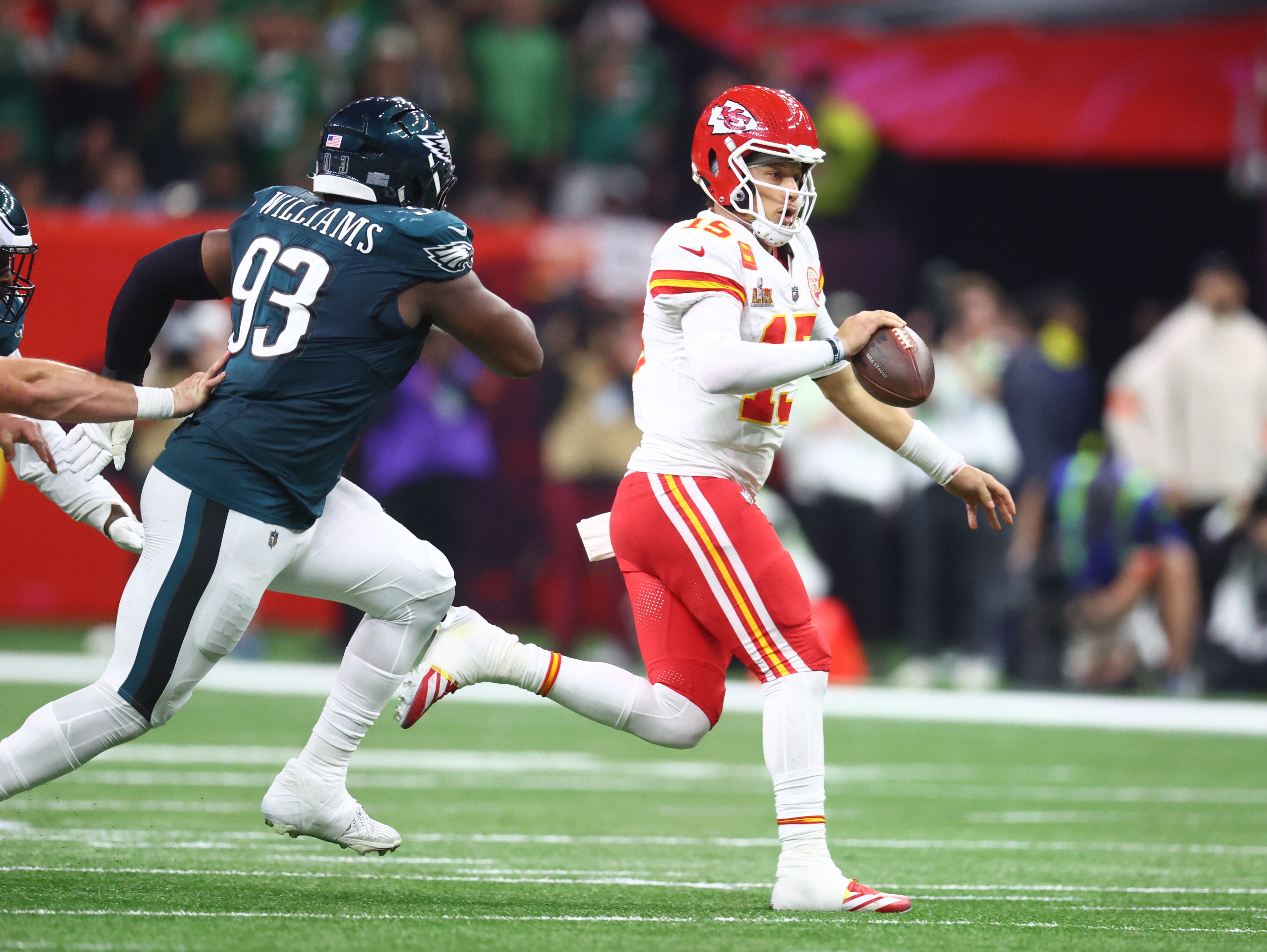 Kansas City Chiefs quarterback Patrick Mahomes (15) runs away from Philadelphia Eagles defensive tackle Milton Williams (93) in the third quarter in Super Bowl LIX at Ceasars Superdome.