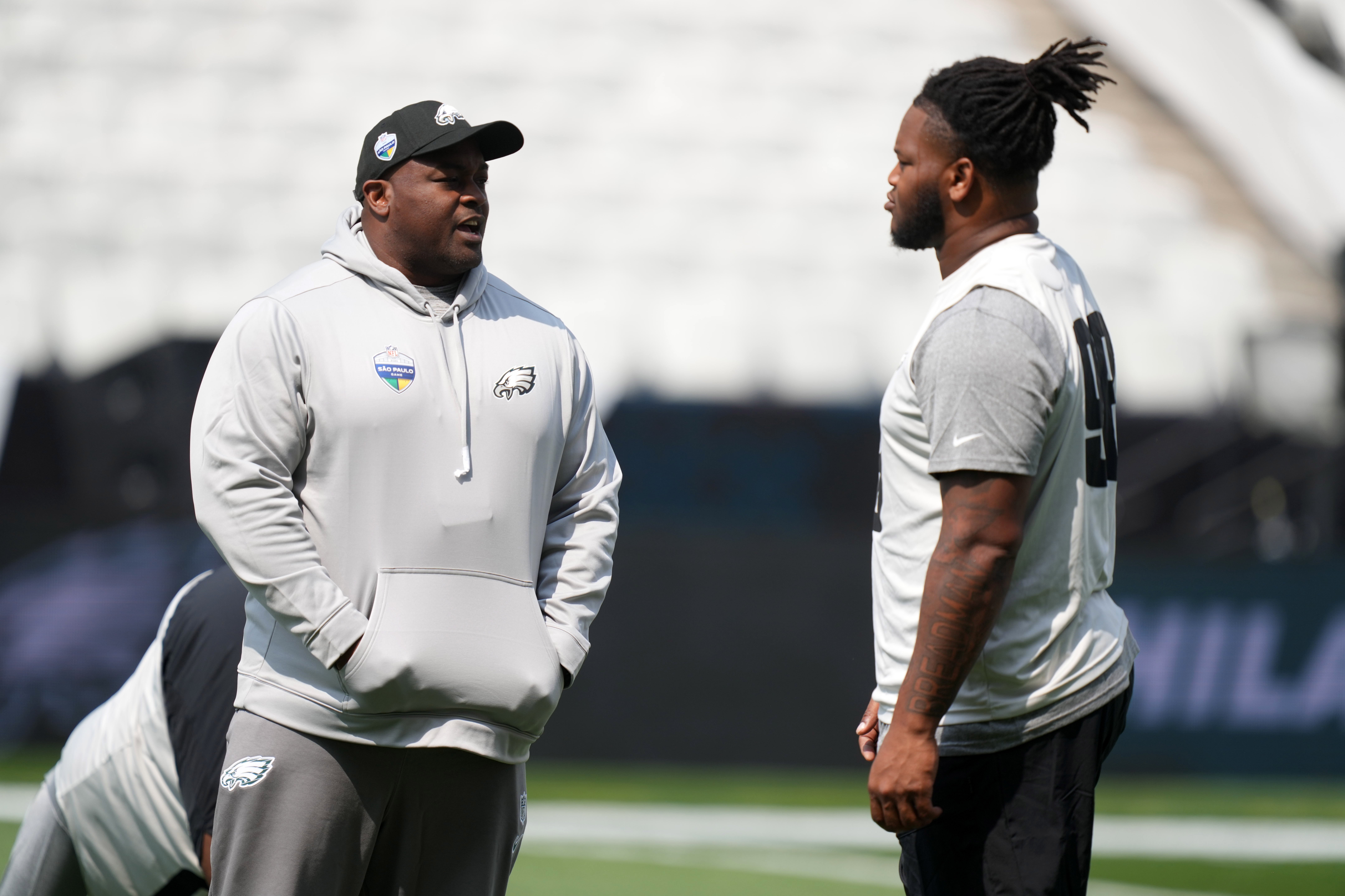 Sep 5, 2024; Sao Paolo, Brazil; Philadelphia Eagles defensive line coach Clint Hurtt talks with defensive tackle Jalen Carter (98) during practice at the Neo Química Arena.