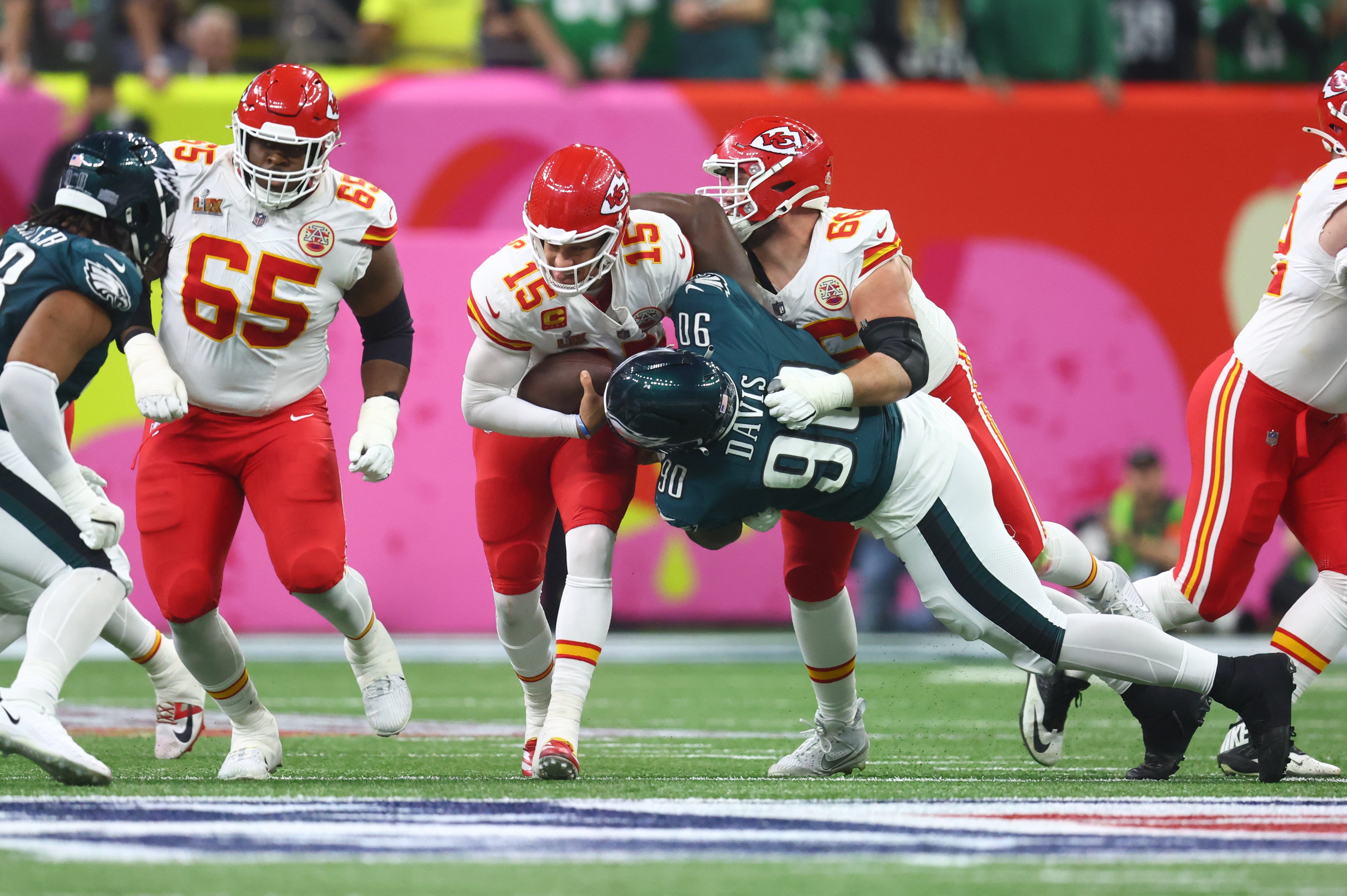 Kansas City Chiefs quarterback Patrick Mahomes (15) is tackled by Philadelphia Eagles defensive tackle Jordan Davis (90) in Super Bowl LIX between the Philadelphia Eagles and the Kansas City Chiefs.