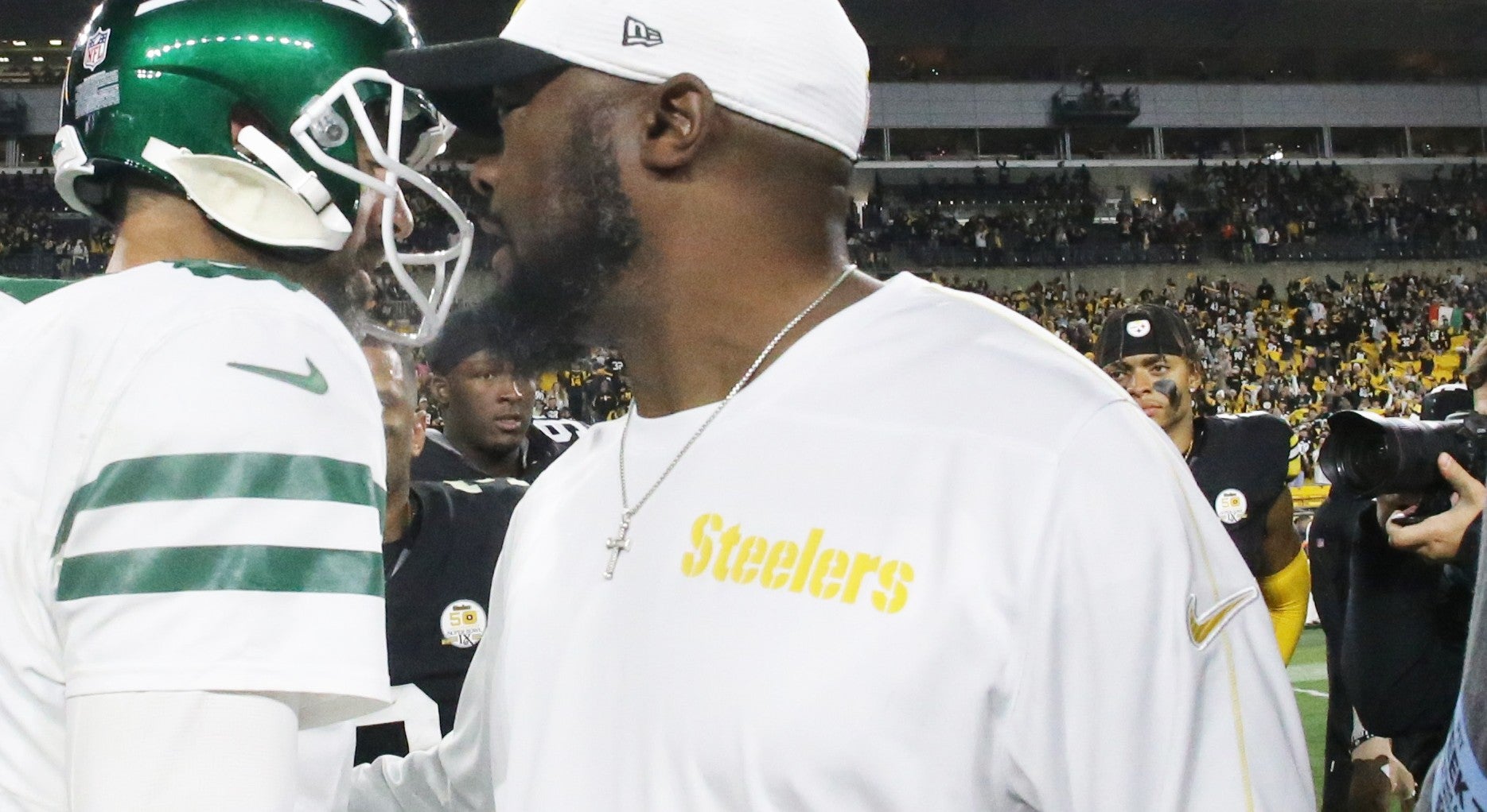 Oct 20, 2024; Pittsburgh, Pennsylvania, USA; New York Jets quarterback Aaron Rodgers (8) and Pittsburgh Steelers head coach Mike Tomlin (right) greet each other after their game at Acrisure Stadium.