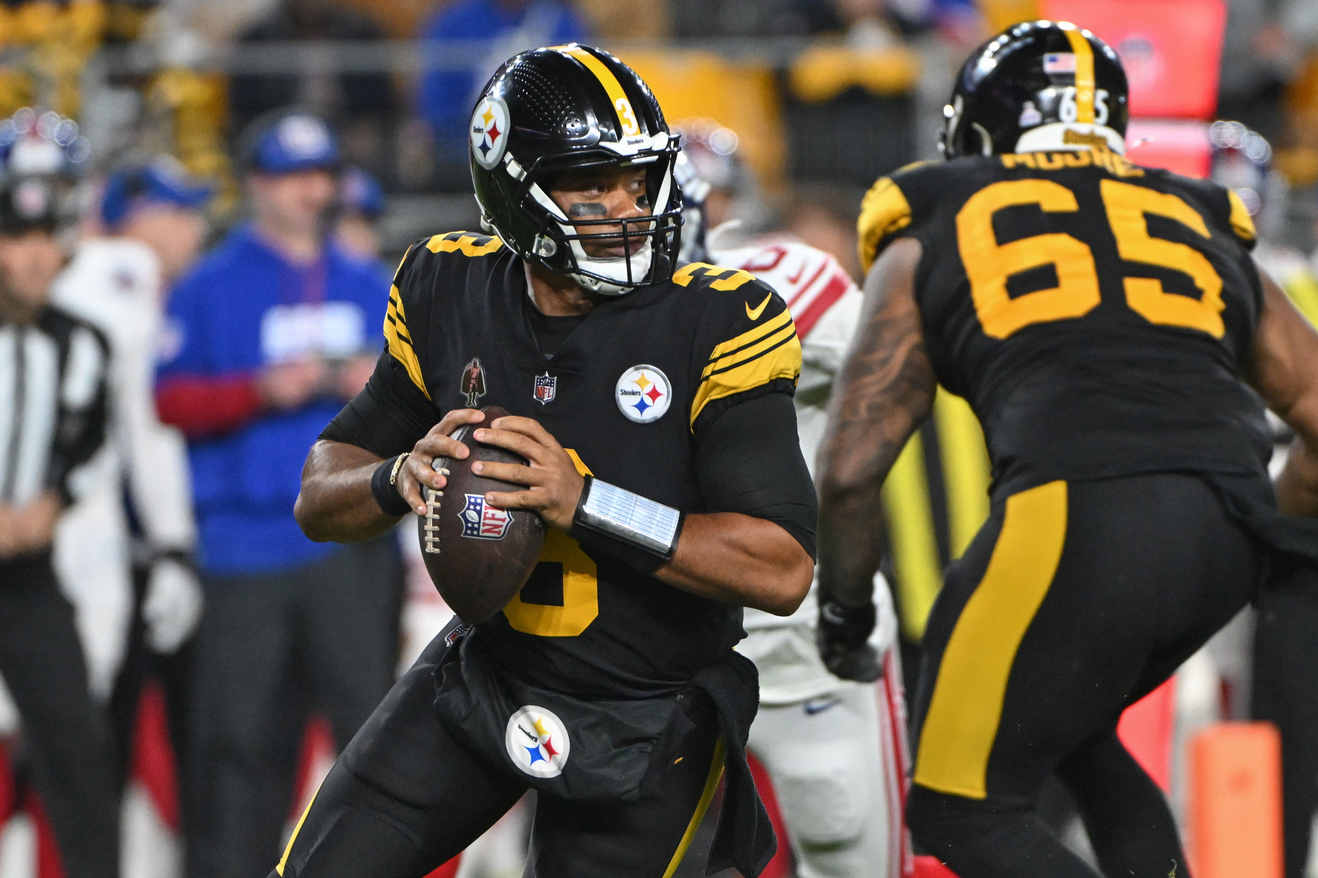 Oct 28, 2024; Pittsburgh, Pennsylvania, USA; Pittsburgh Steelers quarterback Russell Wilson (3) looks to pass against the New York Giants during the first quarter at Acrisure Stadium.
