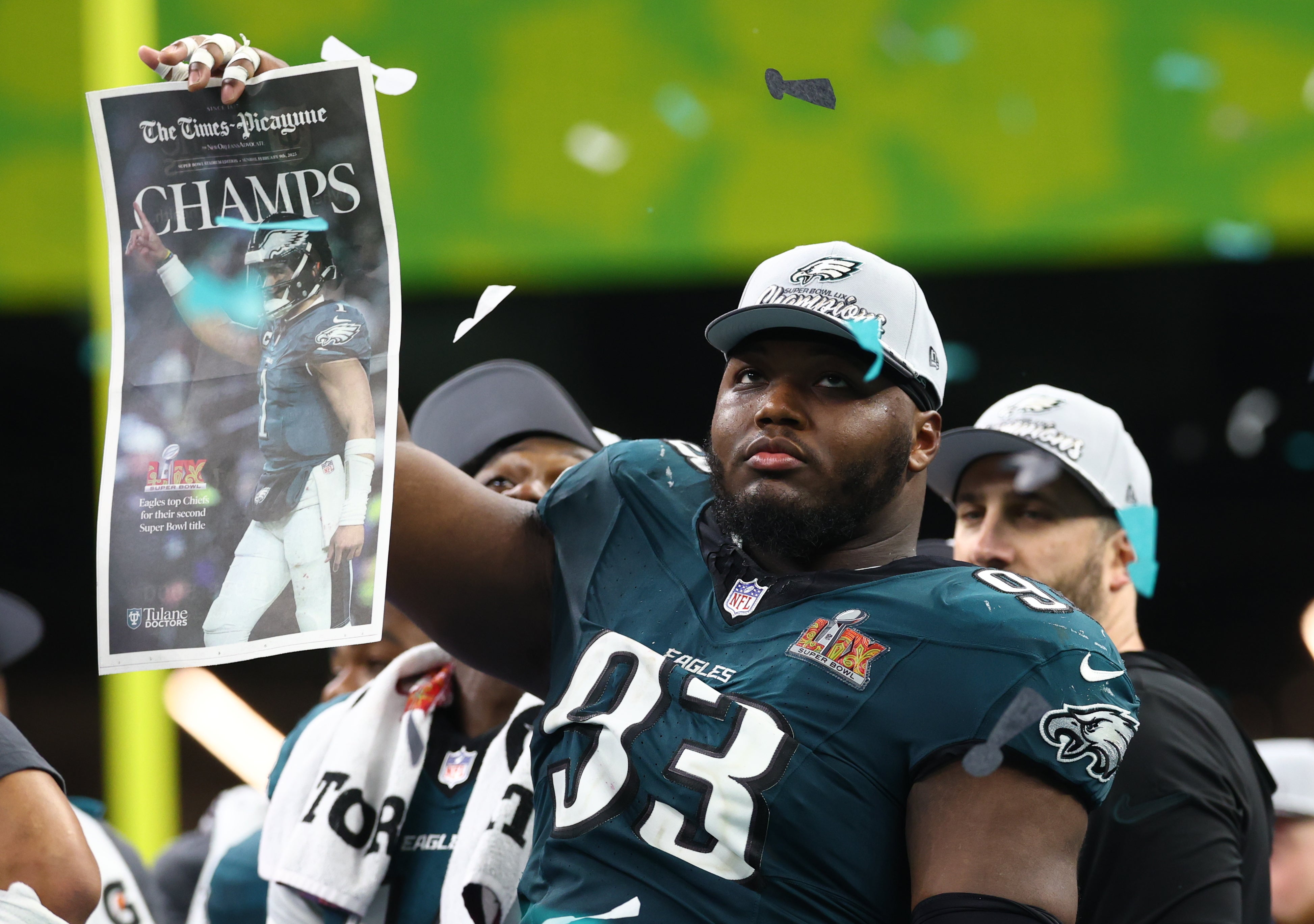 Philadelphia Eagles defensive tackle Milton Williams (93) celebrates on the podium after defeating the Kansas City Chiefs in Super Bowl LIX at Ceasars Superdome.