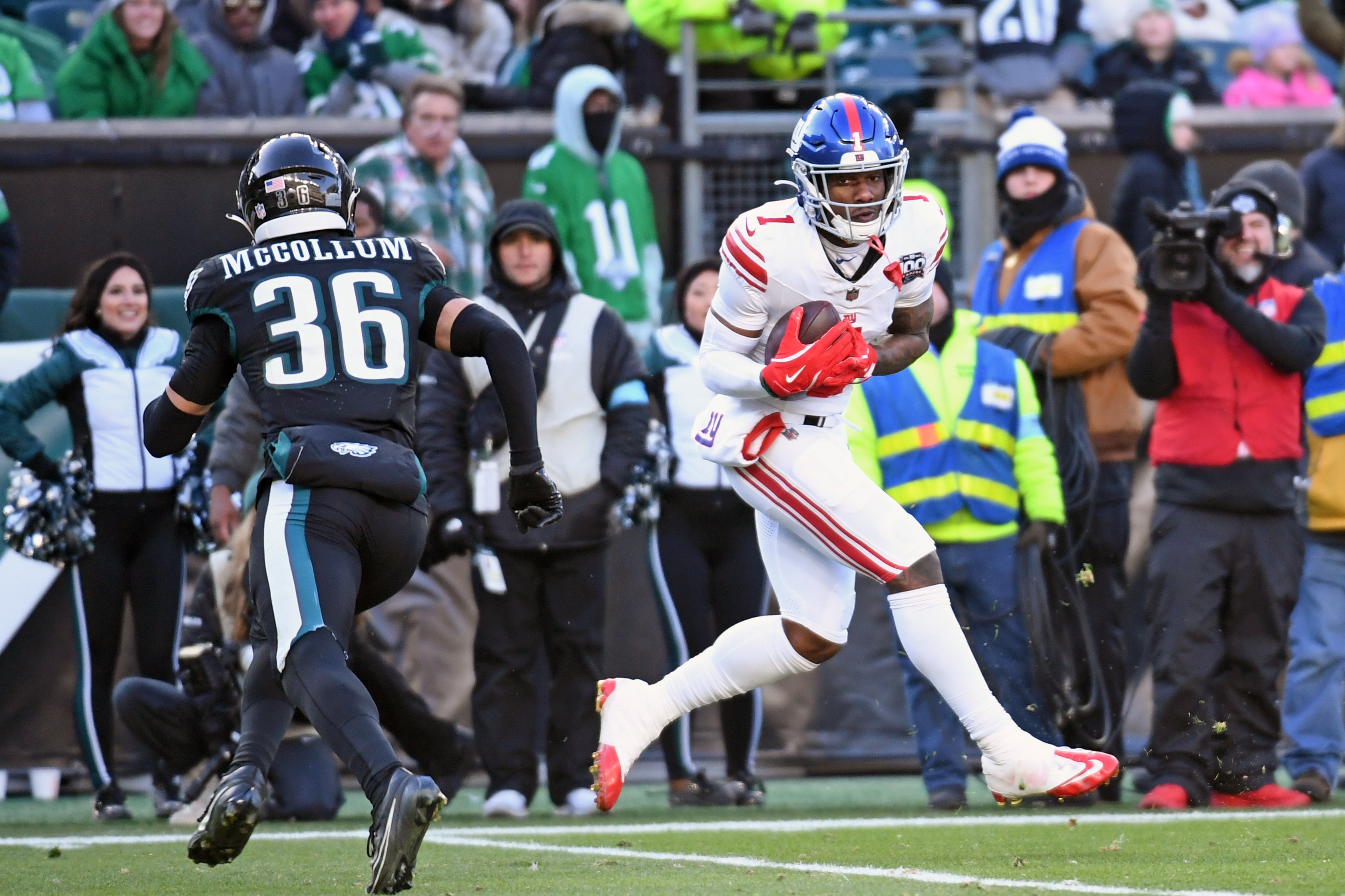 Jan 5, 2025; Philadelphia, Pennsylvania, USA; New York Giants wide receiver Malik Nabers (1) catches pass for a 45-yard touchdown against Philadelphia Eagles safety Tristin McCollum (36) during the fourth quarter at Lincoln Financial Field.