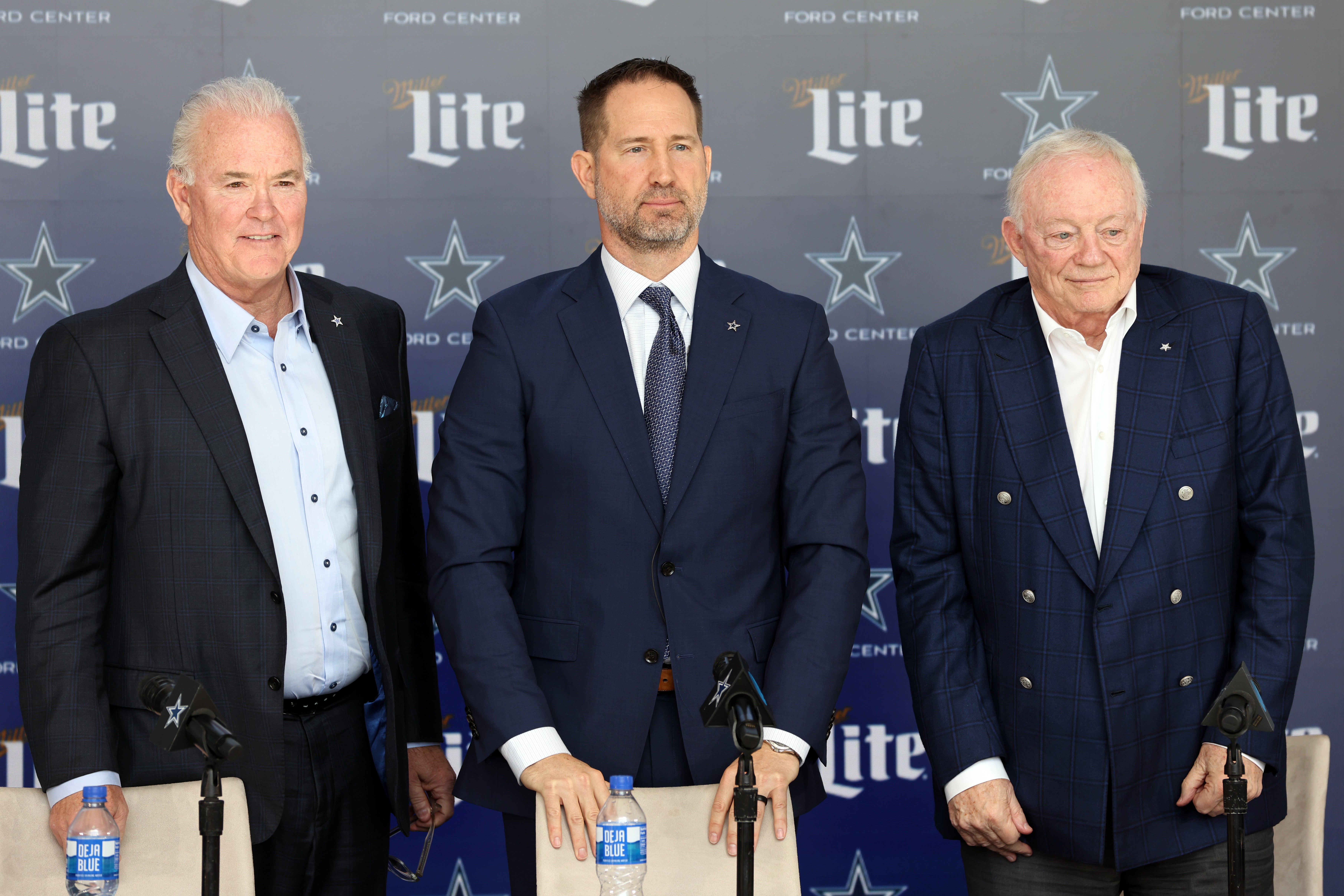 Dallas Cowboys CEO Stephen Jones, head coach Brian Schottenheimer and owner Jerry Jones pose for pictures after a press conference at the Star.