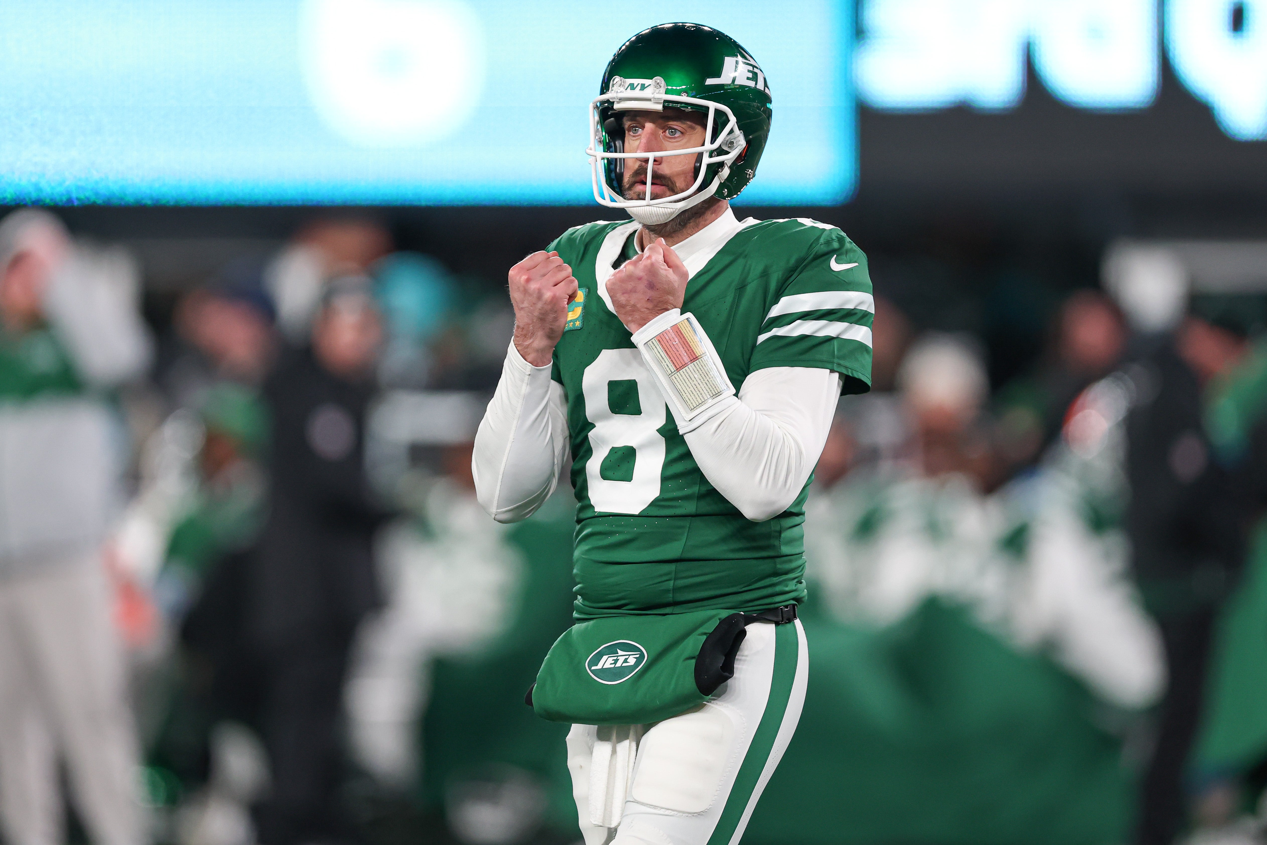 New York Jets quarterback Aaron Rodgers (8) gestures towards the Miami Dolphins bench during the second half at MetLife Stadium.