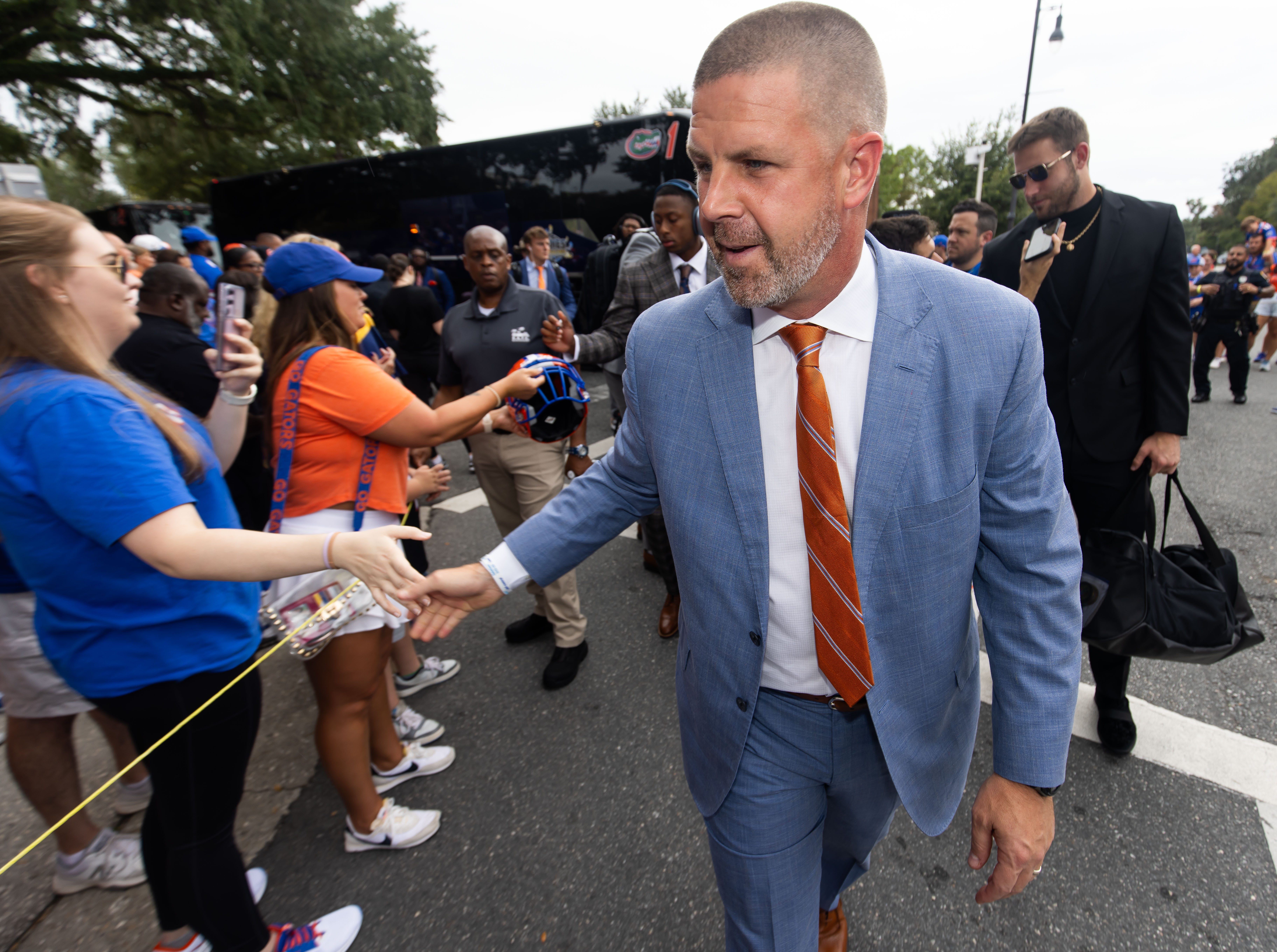 Florida Gators head coach Billy Napier shakes hands with fans during Gator Walk at Ben Hill Griffin Stadium in Gainesville, FL on Saturday, September 7, 2024 before the game against the Samford Bulldogs.
