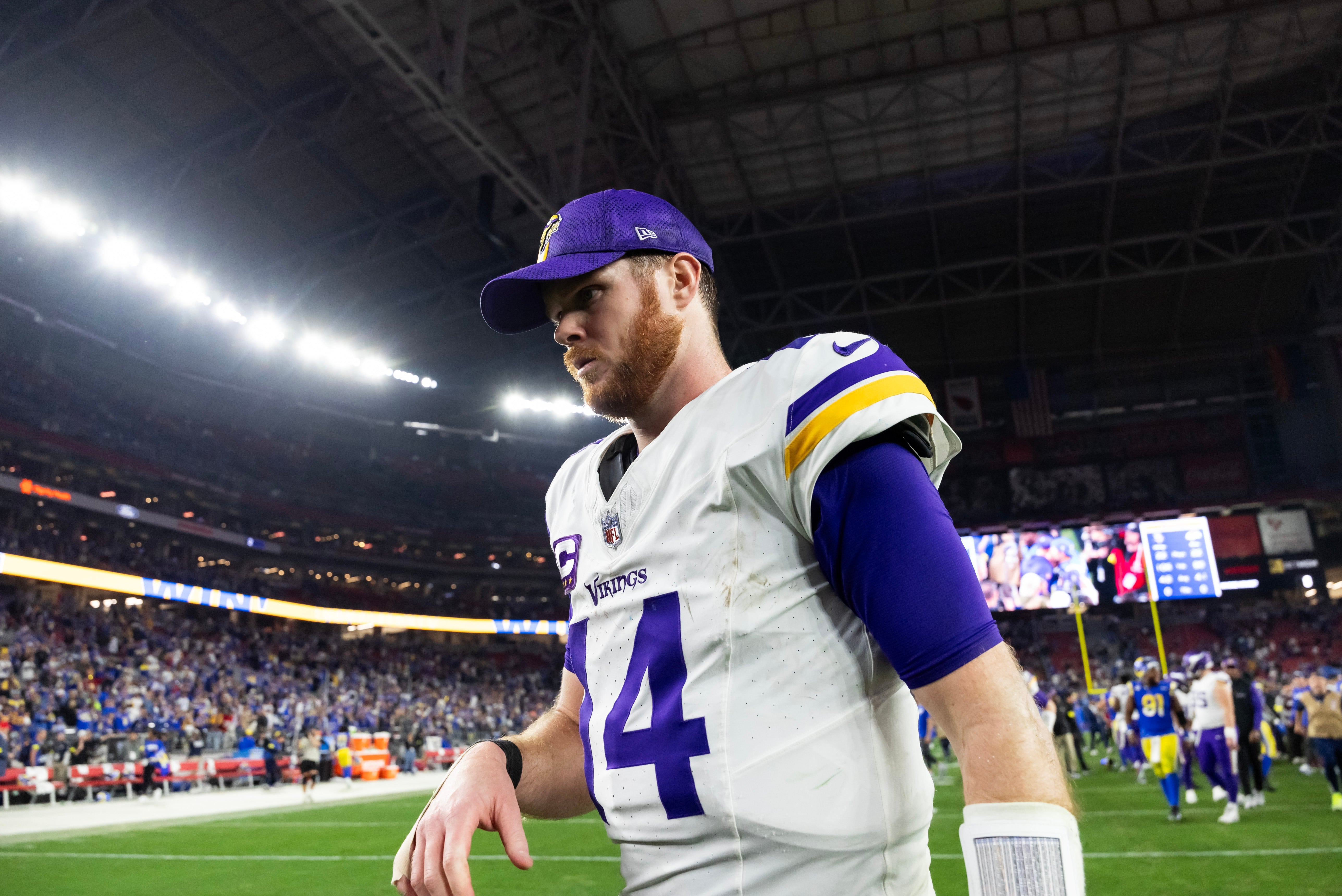 Jan 13, 2025; Glendale, AZ, USA; Minnesota Vikings quarterback Sam Darnold (14) reacts as he walks off the field after losing to the Los Angeles Rams during an NFC wild card game at State Farm Stadium.