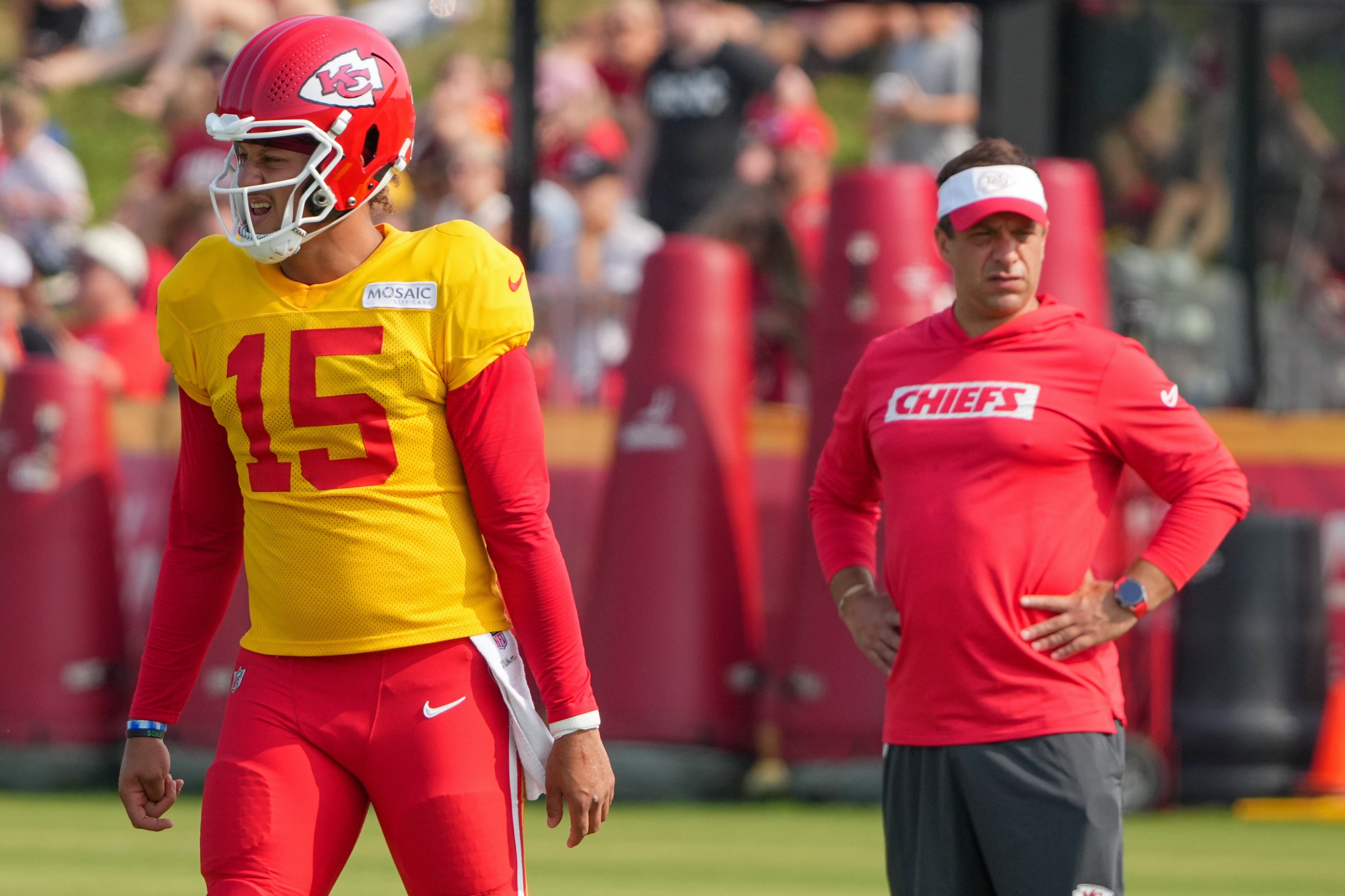 Jul 26, 2024; Kansas City, MO, USA; Kansas City Chiefs quarterback Patrick Mahomes (15) steps to the line as general manager Brett Veach watches in the background during training camp at Missouri Western State University.