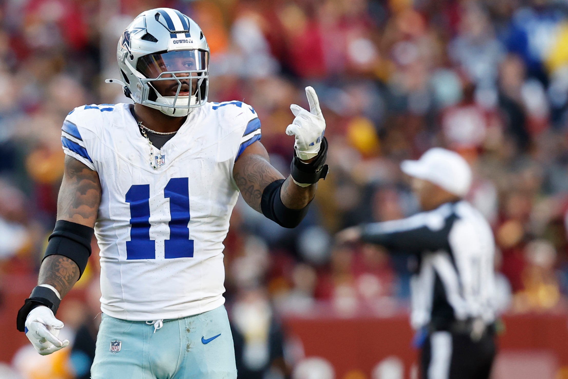 Dallas Cowboys linebacker Micah Parsons (11) gestures to the bench against the Washington Commanders at Northwest Stadium.