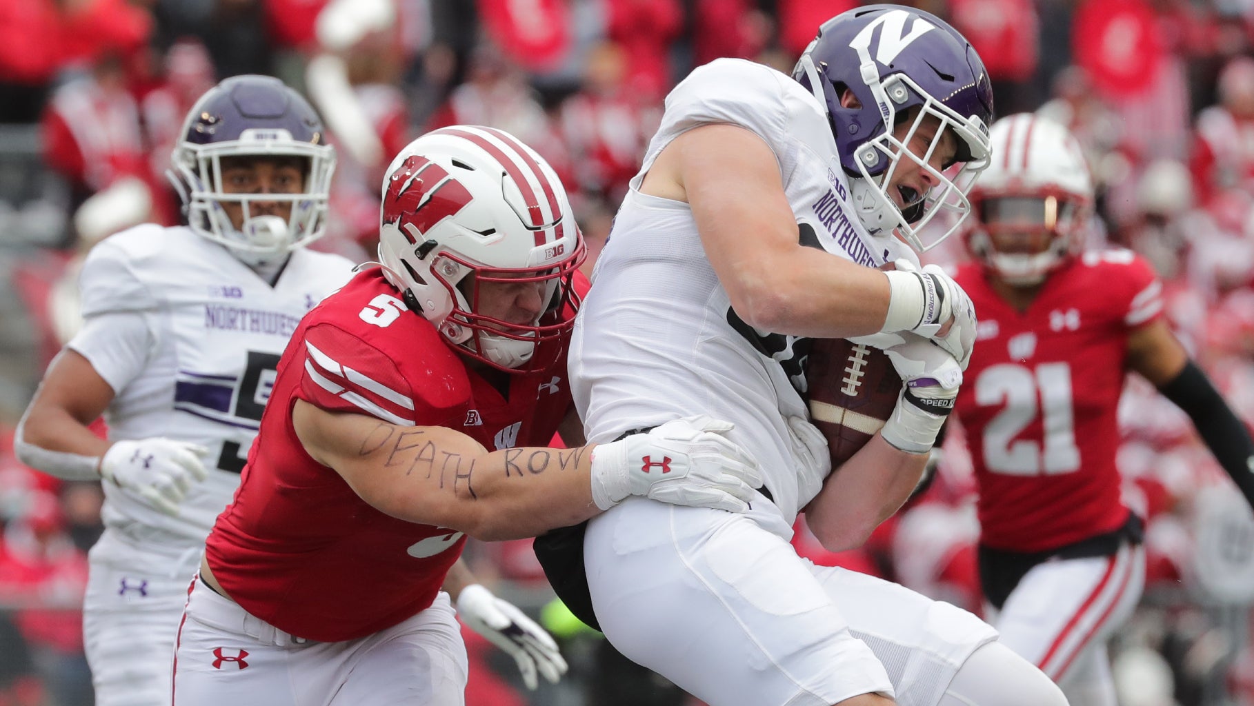 Nov 13, 2021; Madison, WI, USA; Wisconsin linebacker Leo Chenal (5) tackles Northwestern tight end Marshall Lang (88) during the second quarter of their game on Saturday, November 13, 2021 at Camp Randall Stadium in Madison, Wis. Wisconsin beat Northwestern 35-7.