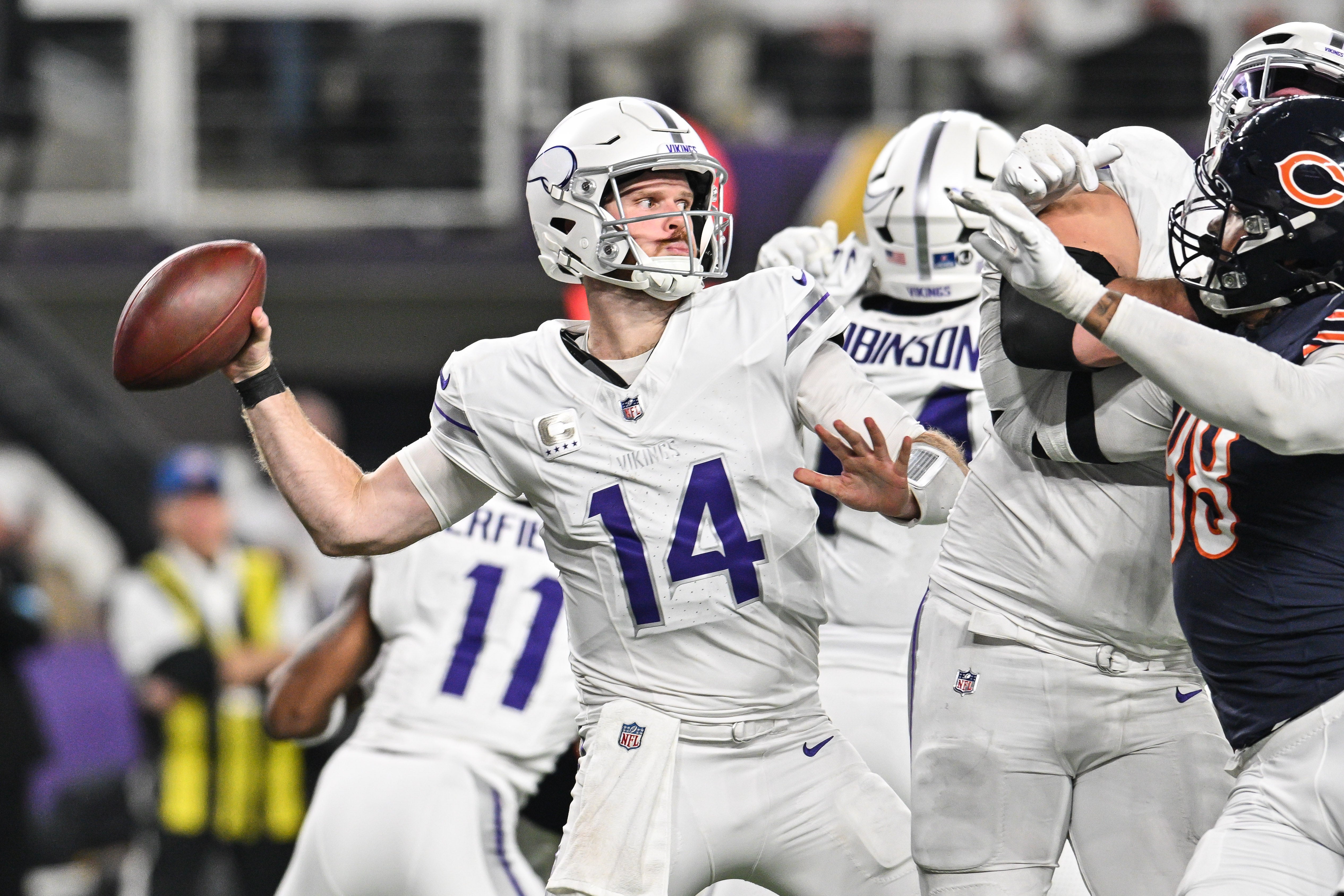 Dec 16, 2024; Minneapolis, Minnesota, USA; Minnesota Vikings quarterback Sam Darnold (14) throws a pass against the Chicago Bears during the third quarter at U.S. Bank Stadium.