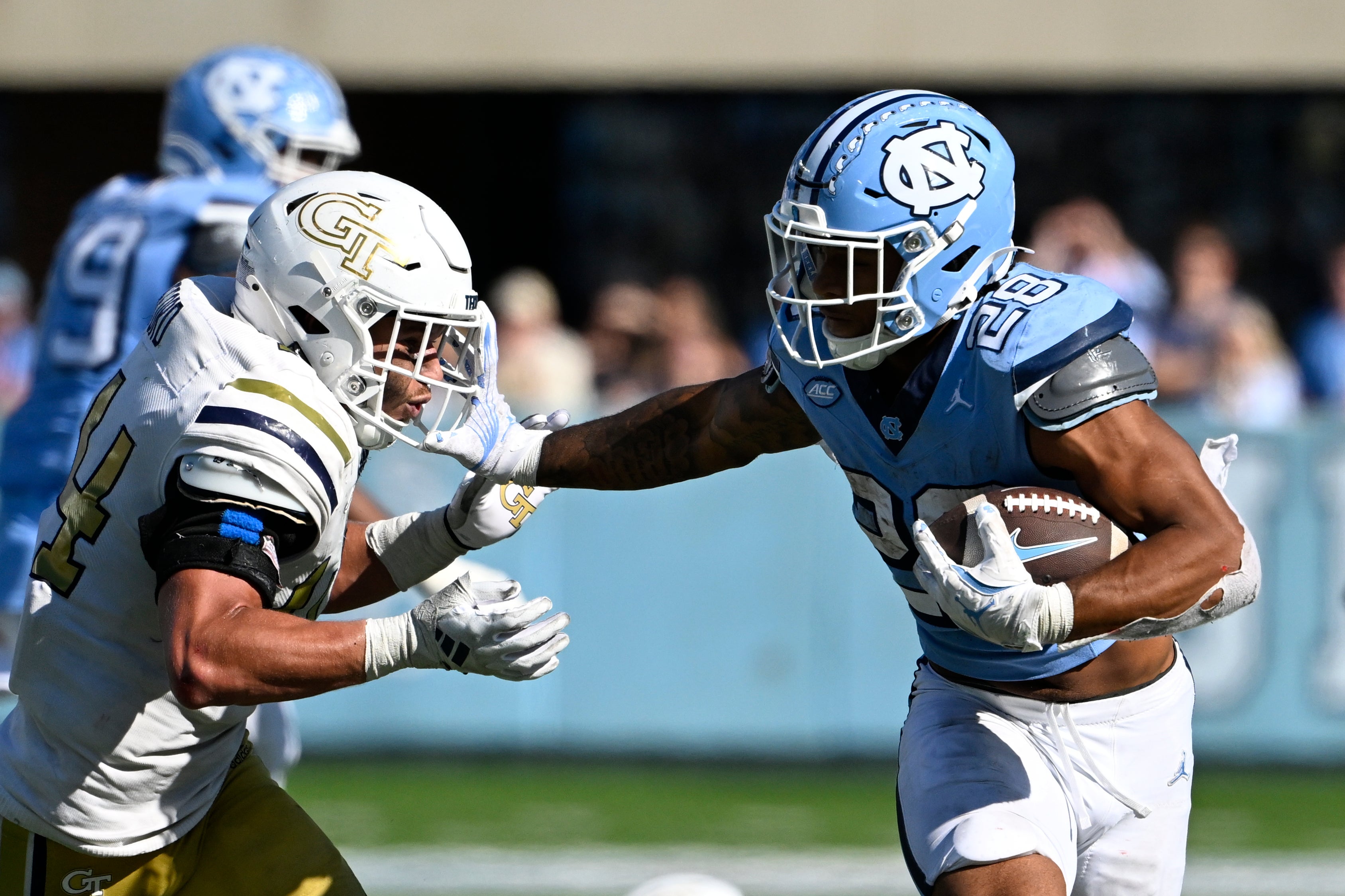 Oct 12, 2024; Chapel Hill, North Carolina, USA; North Carolina Tar Heels running back Omarion Hampton (28) with the ball as Georgia Tech Yellow Jackets linebacker Kyle Efford (44) defends in the fourth quarter at Kenan Memorial Stadium.