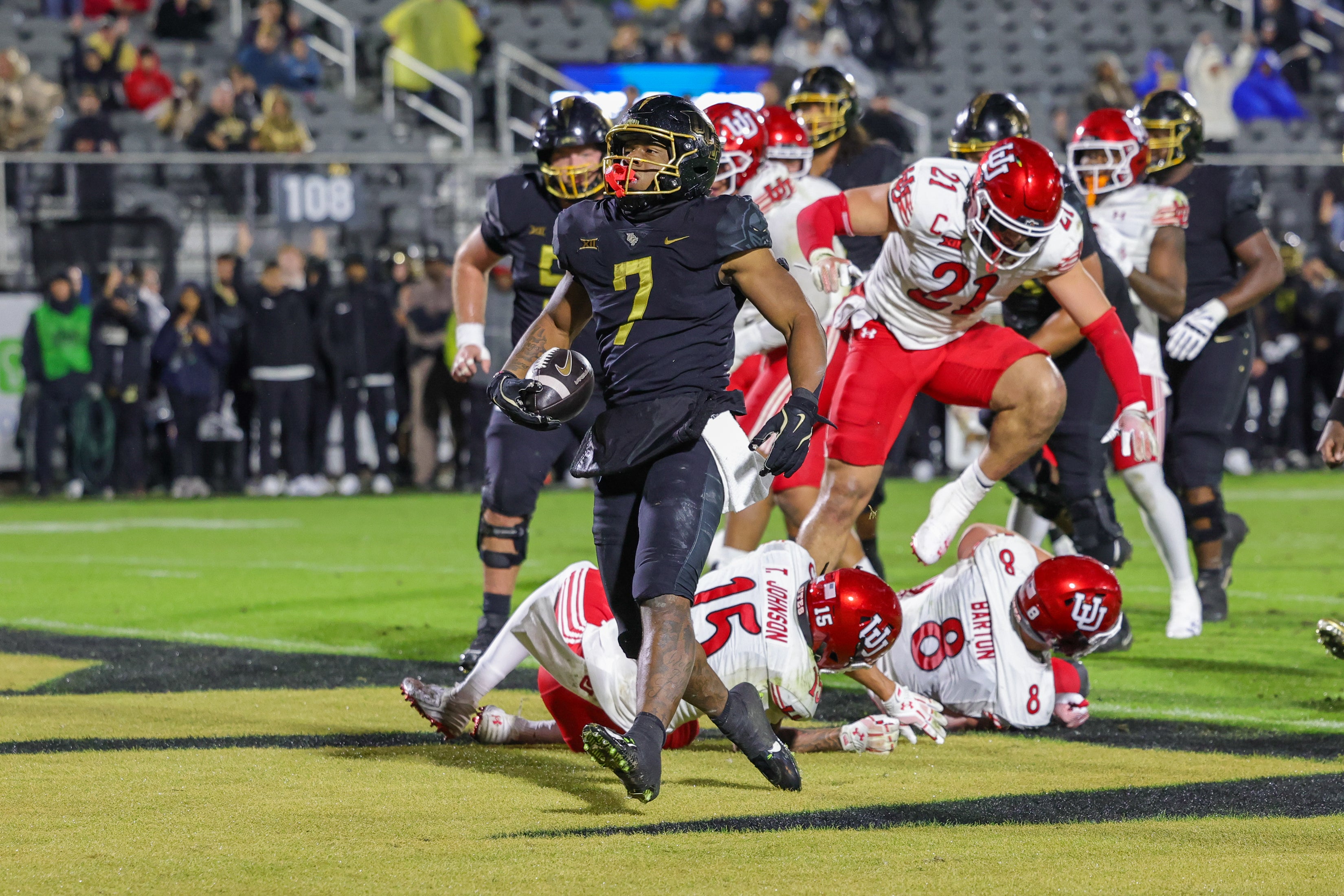Nov 29, 2024; Orlando, Florida, USA; UCF Knights running back RJ Harvey (7) scores a touchdown during the second quarter against the Utah Utes at FBC Mortgage Stadium.