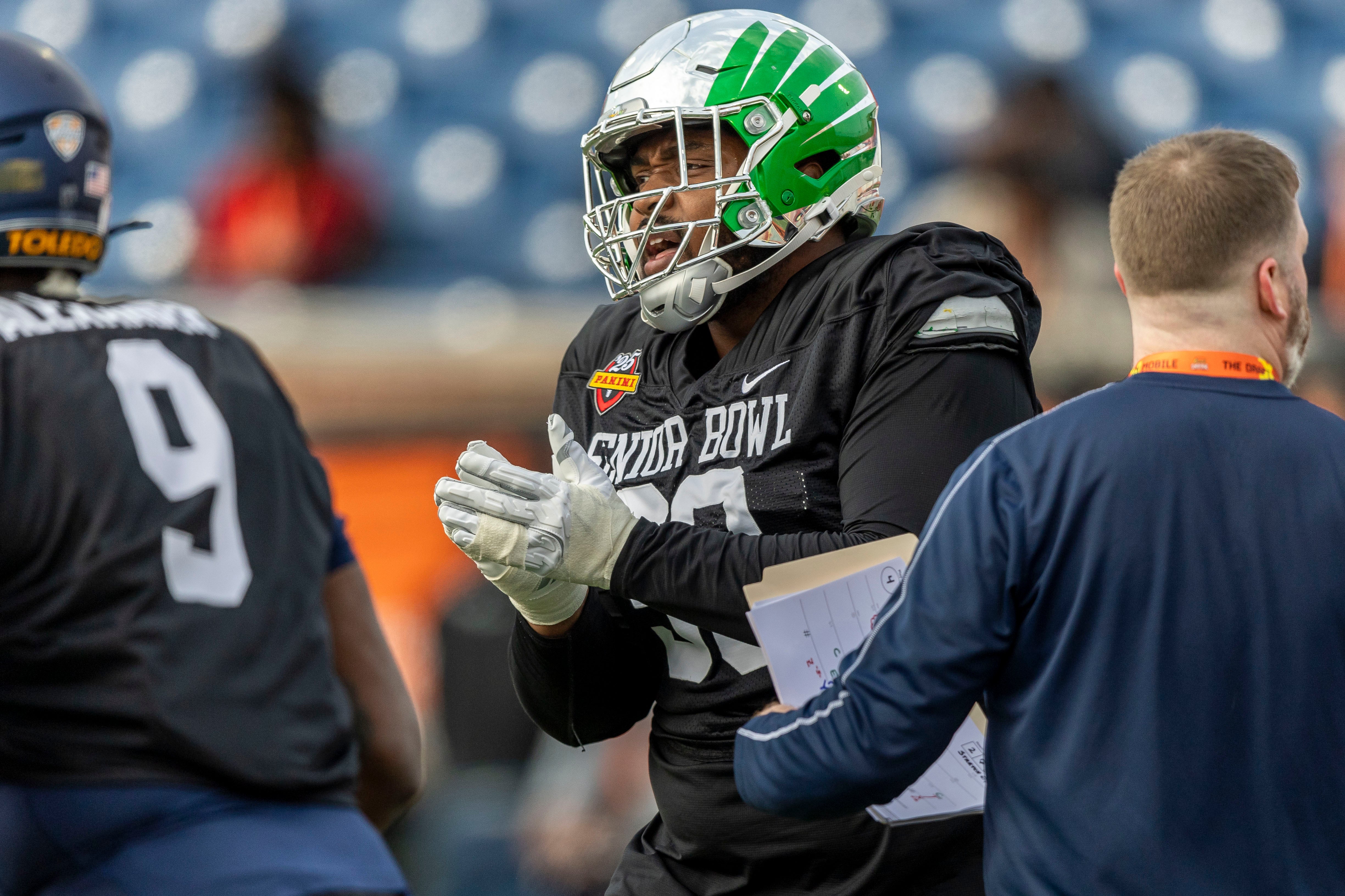 Jan 28, 2025; Mobile, AL, USA; National team defensive lineman Jamaree Caldwell of Oregon (90) celebrates after a play during Senior Bowl practice for the National team at Hancock Whitney Stadium.