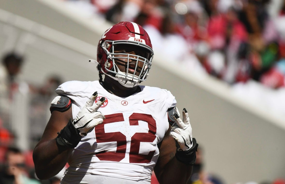 Alabama offensive lineman Tyler Booker (52) celebrates after the offense scored a touchdown during the A-Day scrimmage at Bryant-Denny Stadium.