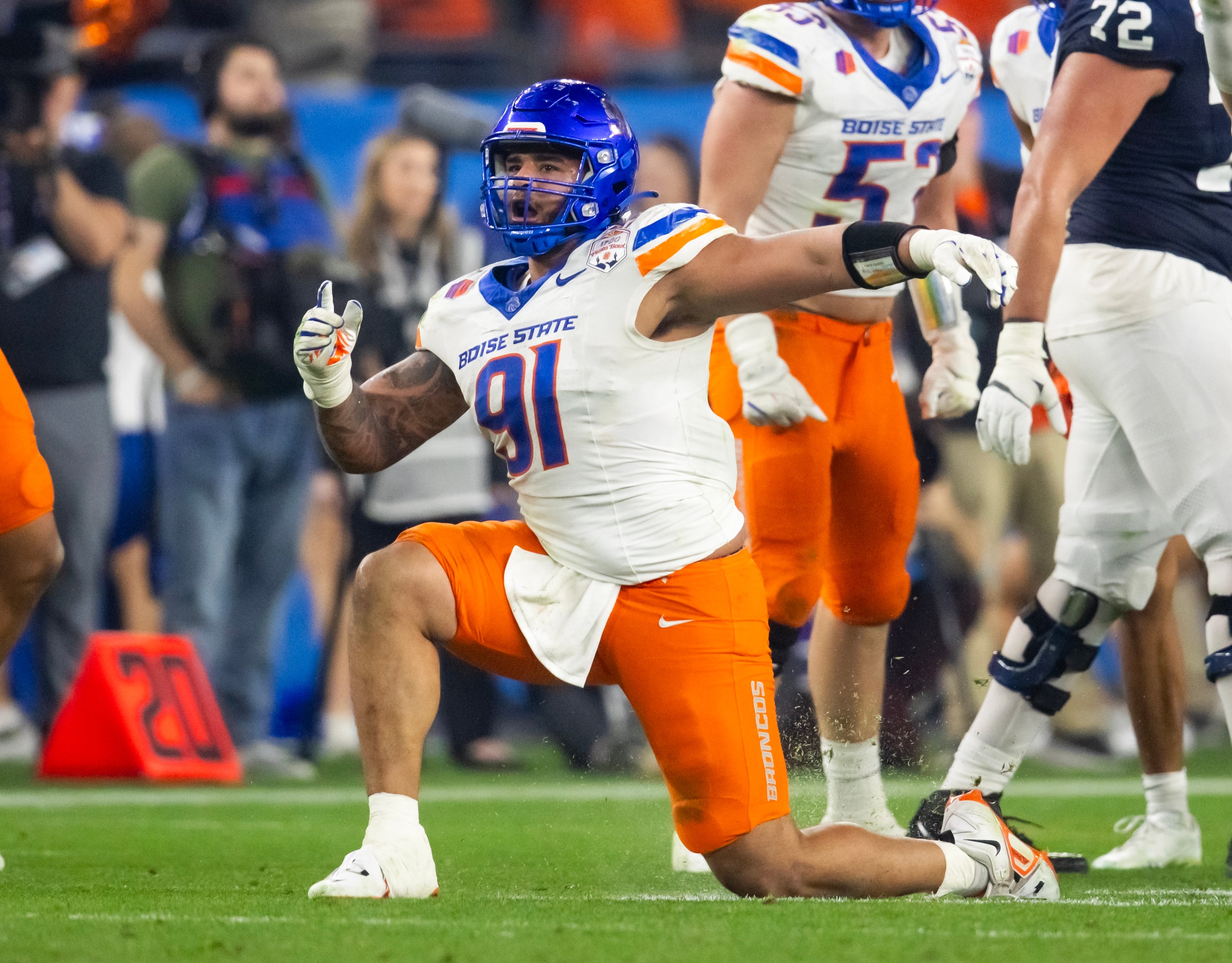 Dec 31, 2024; Glendale, AZ, USA; Boise State Broncos defensive end Ahmed Hassanein (91) celebrates a play against the Penn State Nittany Lions during the Fiesta Bowl at State Farm Stadium.