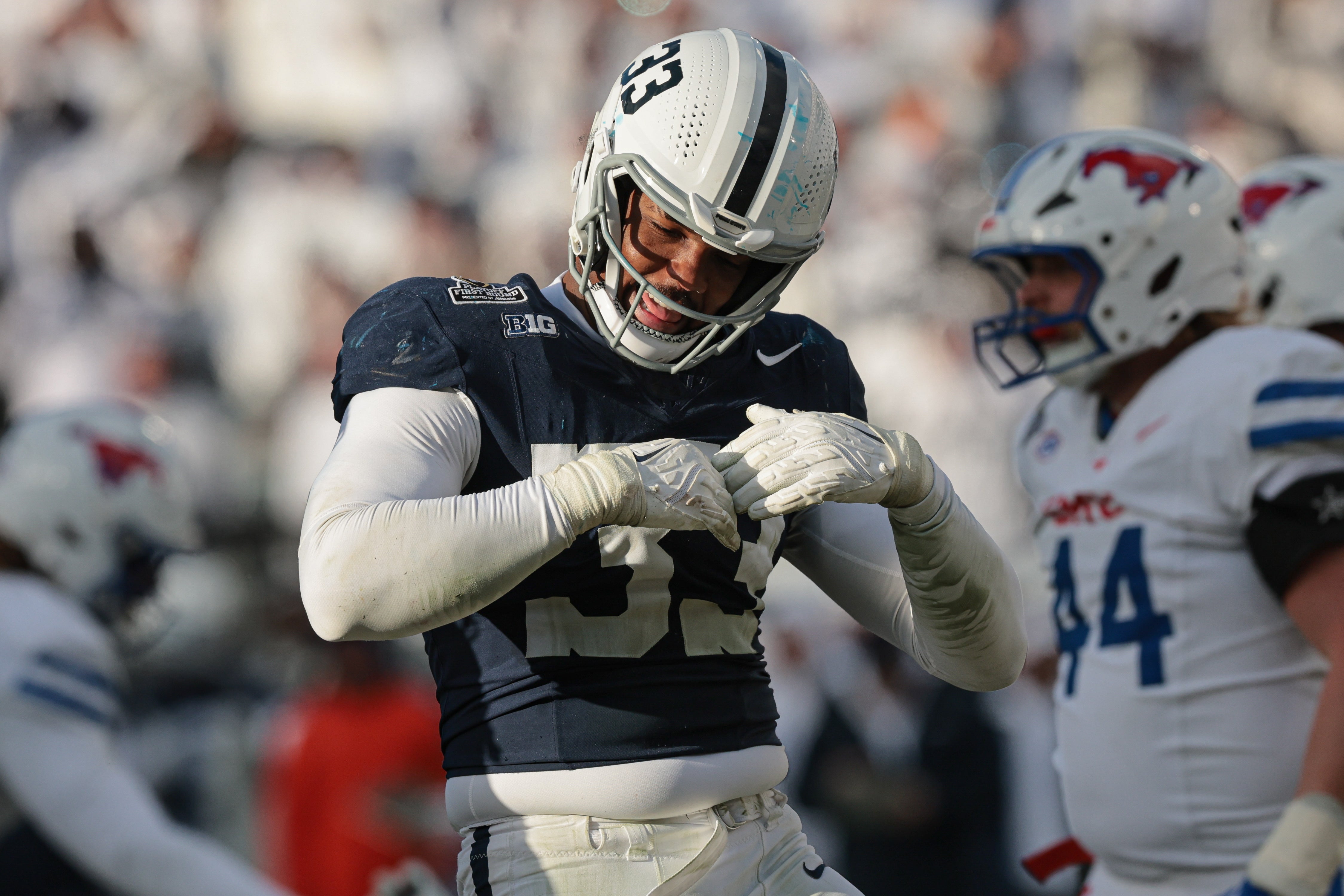 Dec 21, 2024; University Park, Pennsylvania, USA; Penn State Nittany Lions defensive end Dani Dennis-Sutton (33) reacts after a defensive stop during the second half against the Southern Methodist Mustangs at Beaver Stadium.