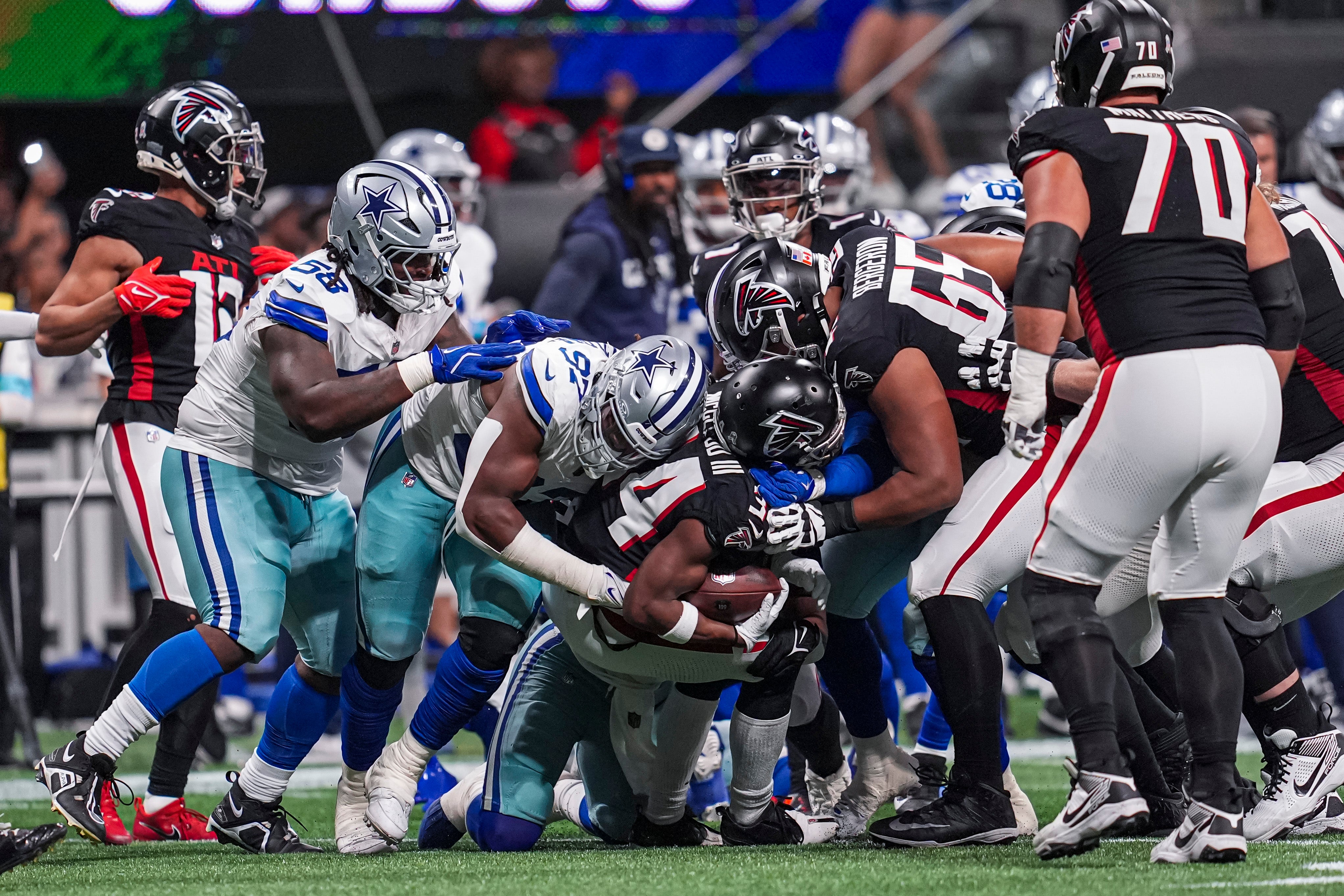 Atlanta Falcons wide receiver Ray-Ray McCloud III (34) is tackled by Dallas Cowboys defensive tackle Osa Odighizuwa (97) during the second half at Mercedes-Benz Stadium.