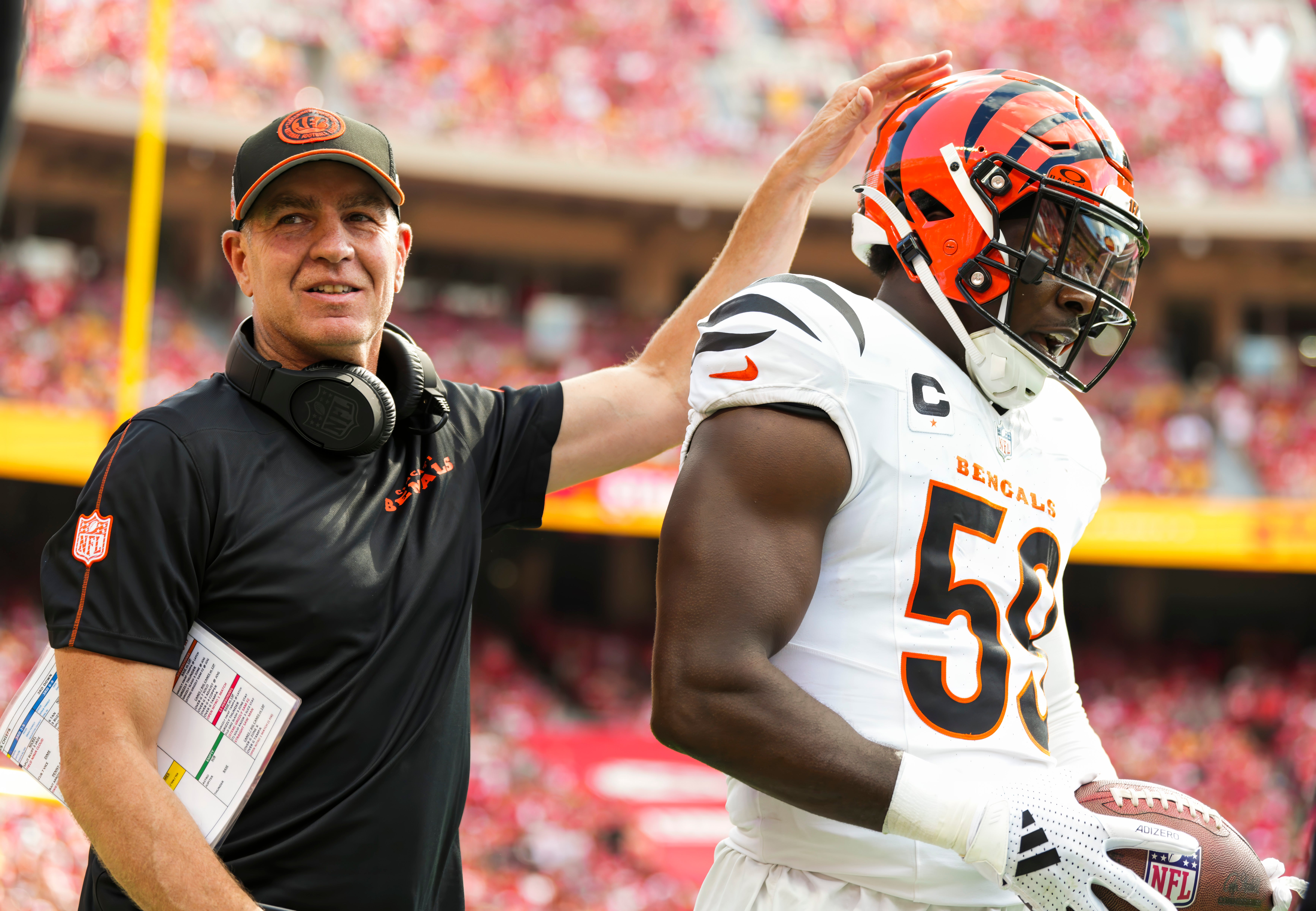 Sep 15, 2024; Kansas City, Missouri, USA; Cincinnati Bengals defensive coordinator Lou Anarumo congratulates linebacker Akeem Davis-Gaither (59) after an interception during the first half against the Kansas City Chiefs at GEHA Field at Arrowhead Stadium.