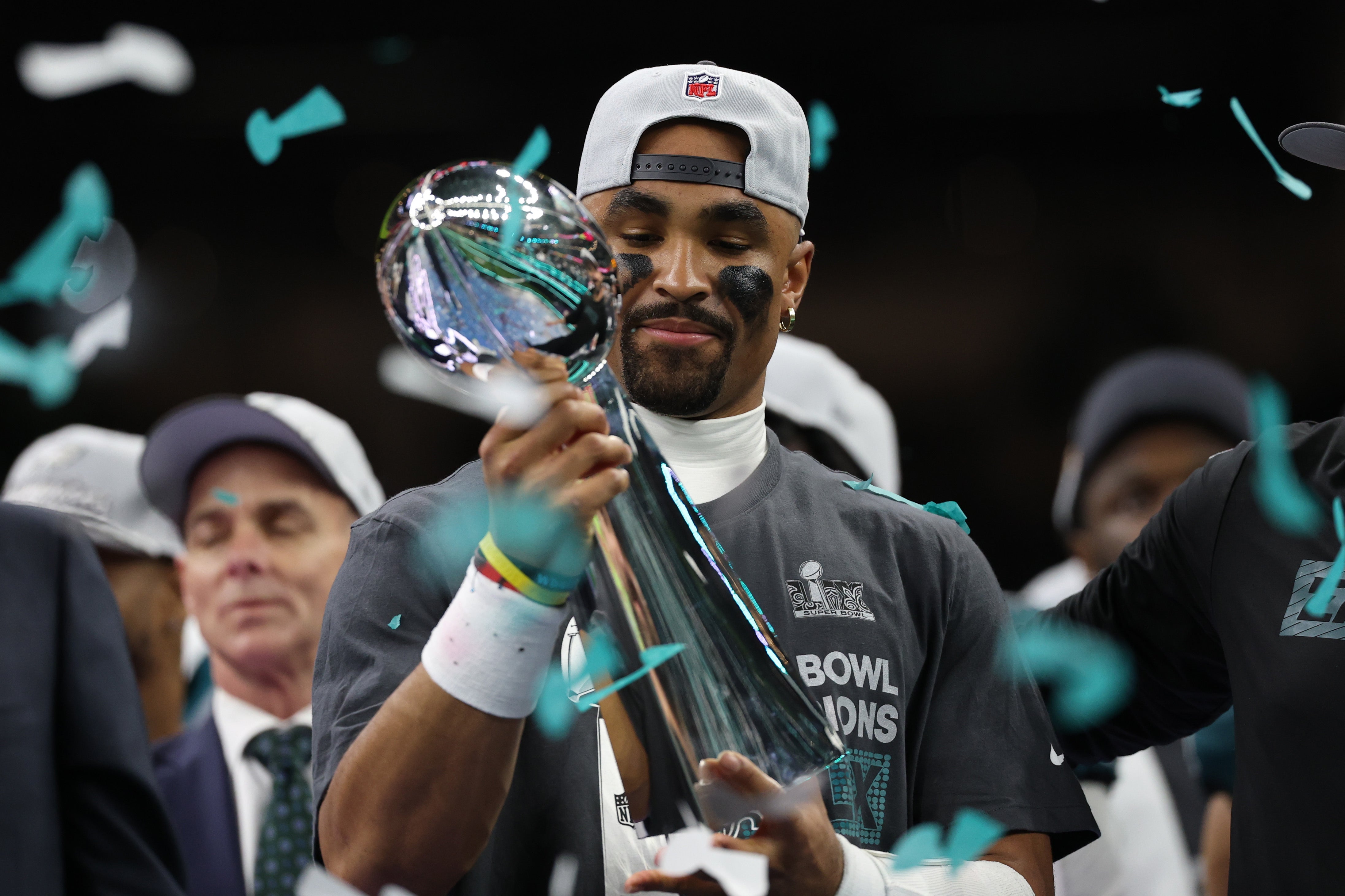 Philadelphia Eagles quarterback Jalen Hurts holds the Lombardi Trophy during the championship trophy presentation after the Eagles' game against the Kansas City Chiefs in Super Bowl LIX at Caesars Superdome.
