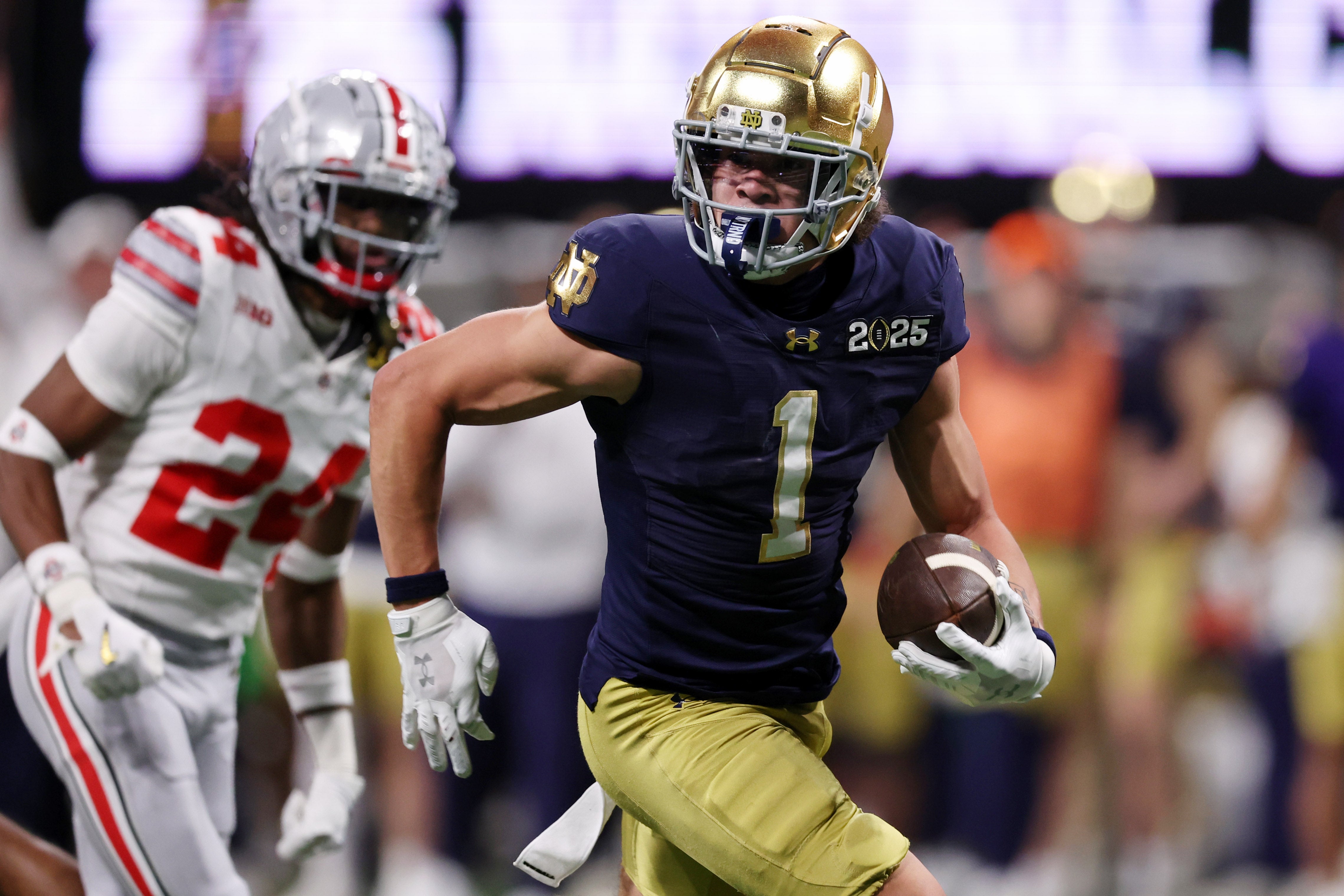Notre Dame Fighting Irish wide receiver Jaden Greathouse (1) runs with the ball for a touchdown against the Ohio State Buckeyes during the second half the CFP National Championship college football game at Mercedes-Benz Stadium.