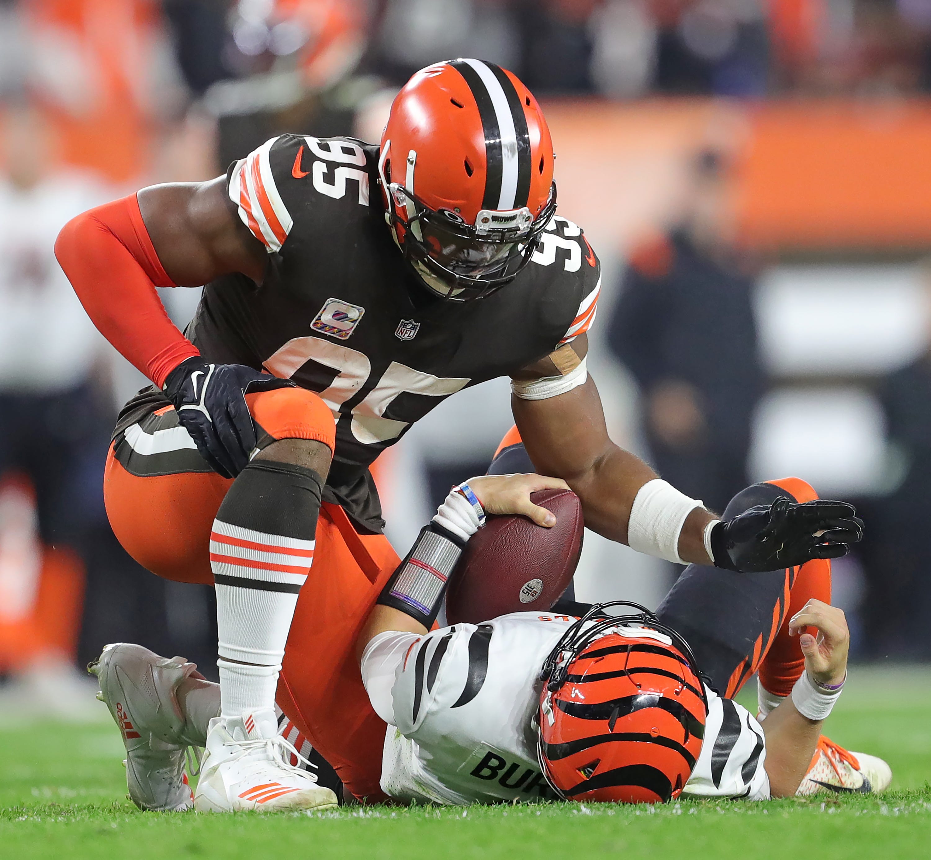 Cleveland Browns defensive end Myles Garrett (95) pats Cincinnati Bengals quarterback Joe Burrow (9) after sacking him during the second half of an NFL football game at FirstEnergy Stadium, Monday.