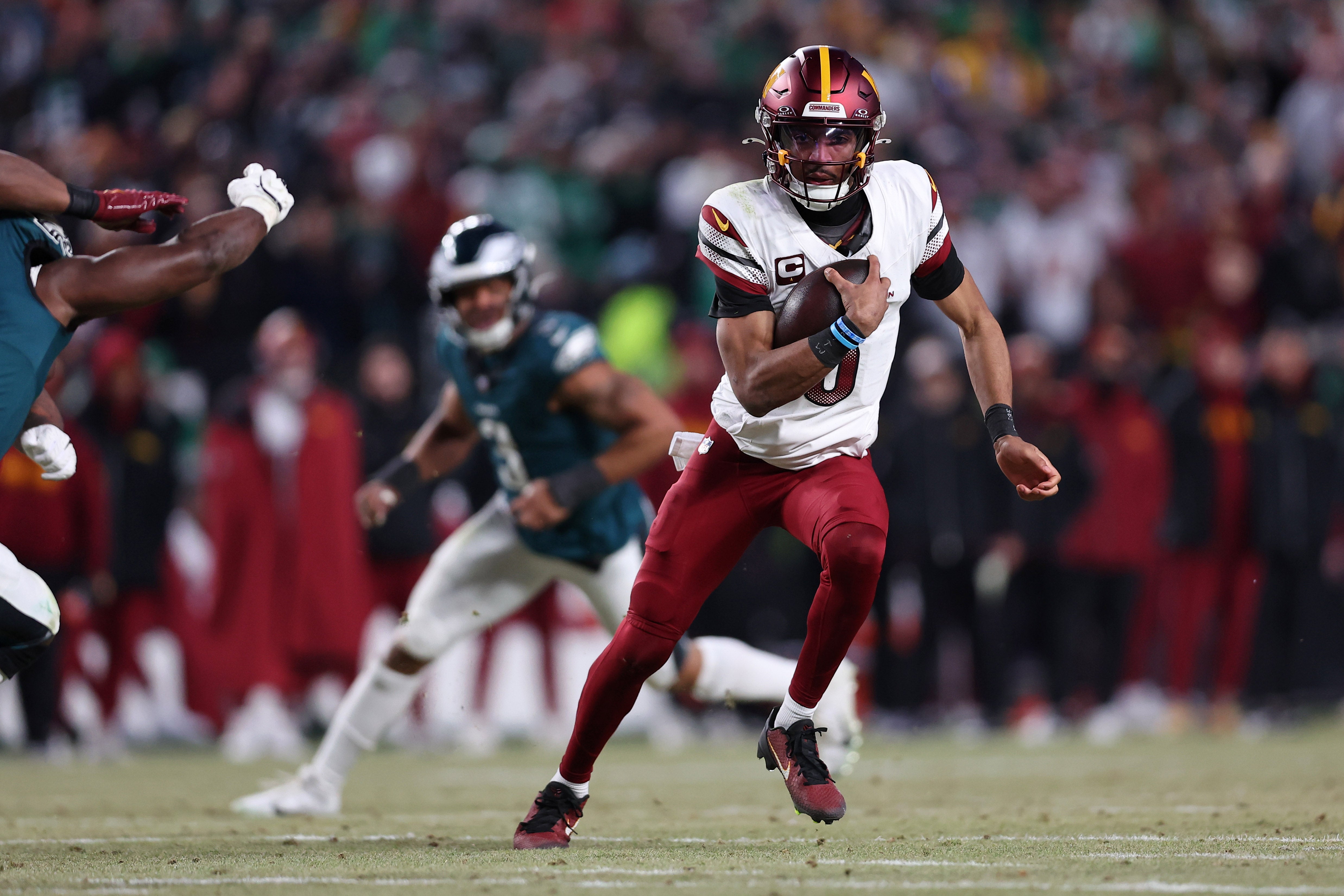 Jan 26, 2025; Philadelphia, PA, USA; Washington Commanders quarterback Jayden Daniels (5) runs with the ball against the Philadelphia Eagles during the second half in the NFC Championship game at Lincoln Financial Field.