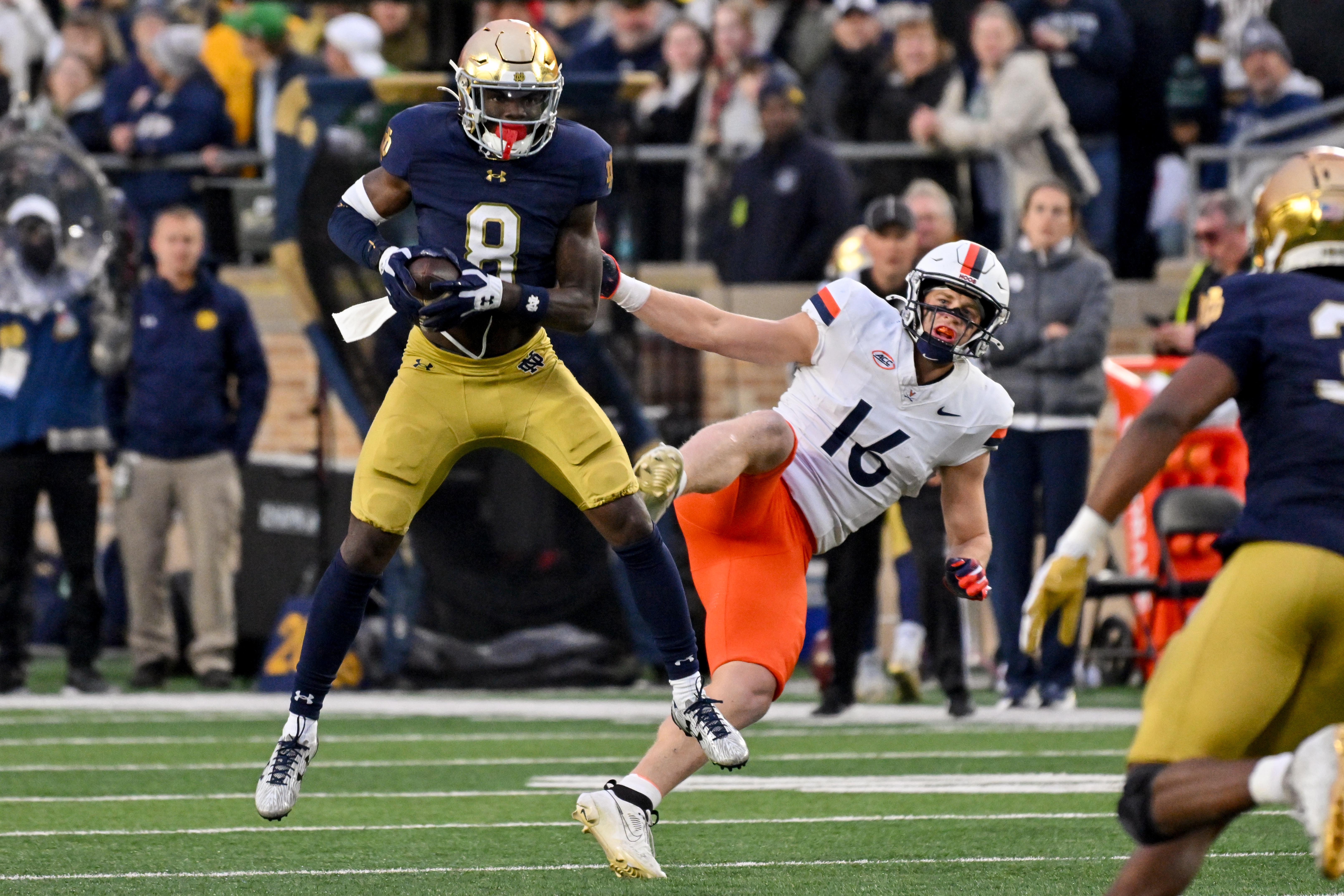 Notre Dame Fighting Irish safety Adon Shuler (8) intercepts a pass intended for Virginia Cavaliers tight end Tyler Neville (16) in the second quarter at Notre Dame Stadium. 