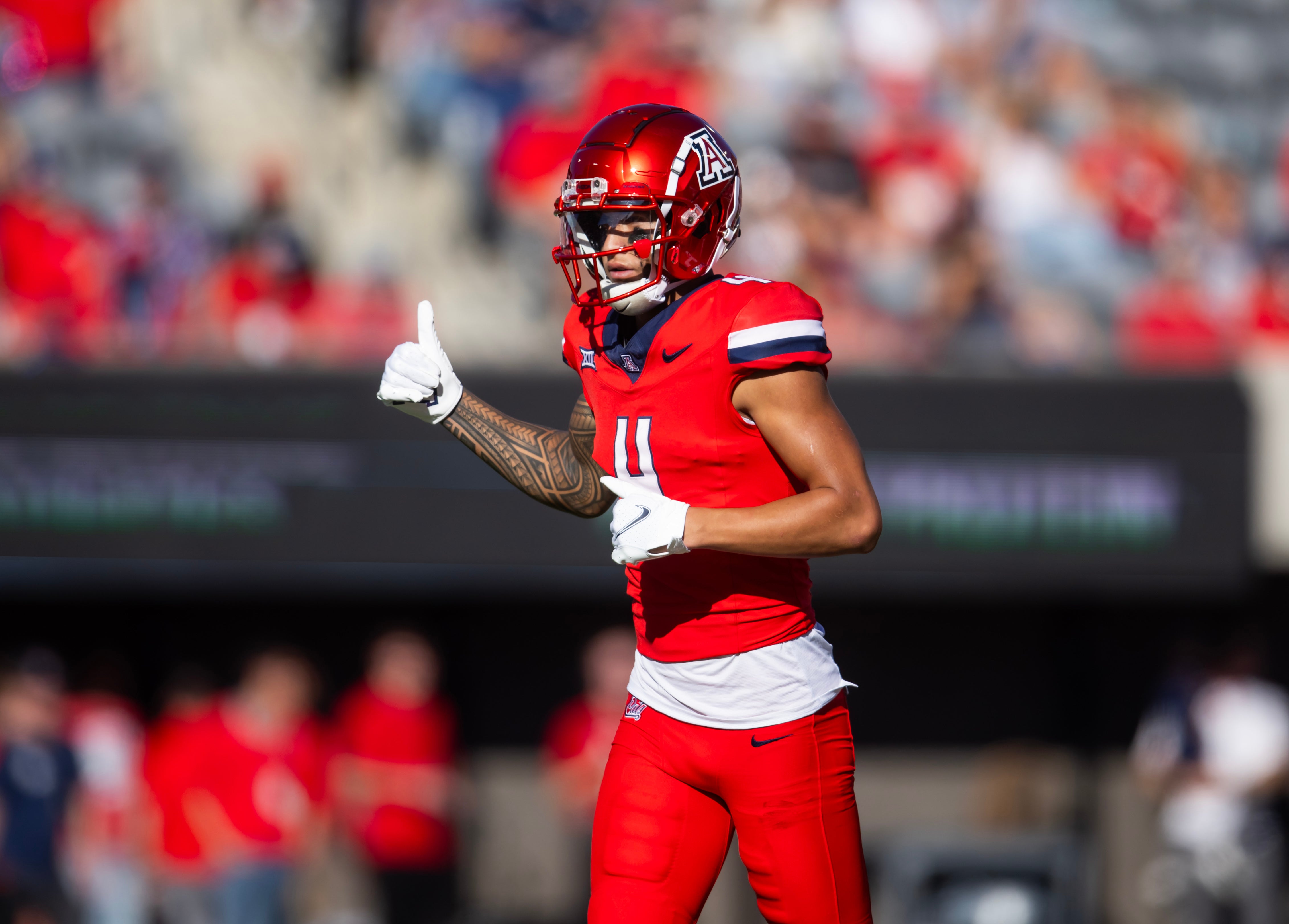 Nov 30, 2024; Tucson, Arizona, USA; Arizona Wildcats wide receiver Tetairoa McMillan (4) against the Arizona State Sun Devils during the Territorial Cup at Arizona Stadium.