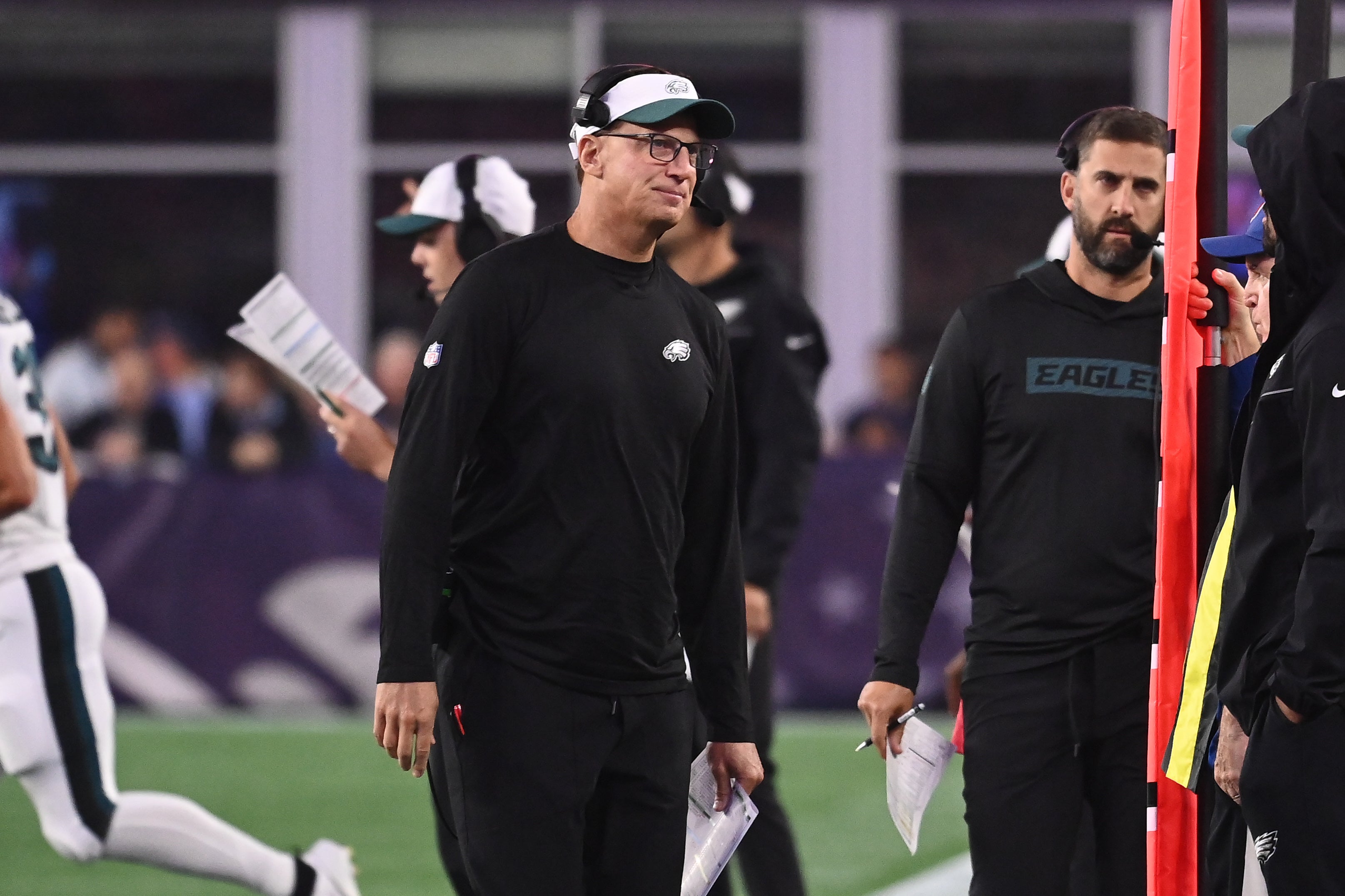 Philadelphia Eagles quarterbacks coach Doug Nussmeier works on the sideline during the first half against the New England Patriots at Gillette Stadium.