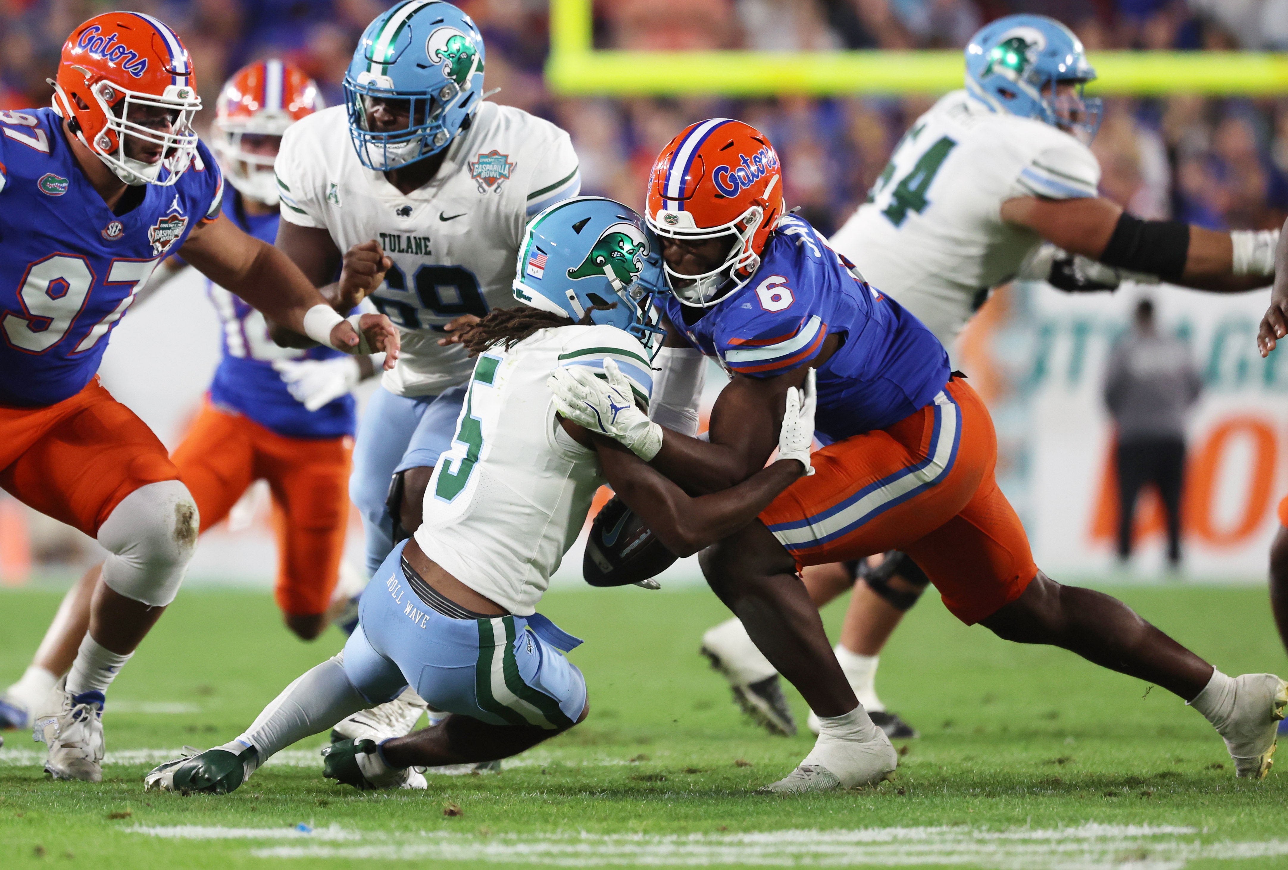 Dec 20, 2024; Tampa, FL, USA; Florida Gators linebacker Shemar James (6) and Tulane Green Wave wide receiver Yulkeith Brown (5) go after the loose ball during the second half at Raymond James Stadium.
