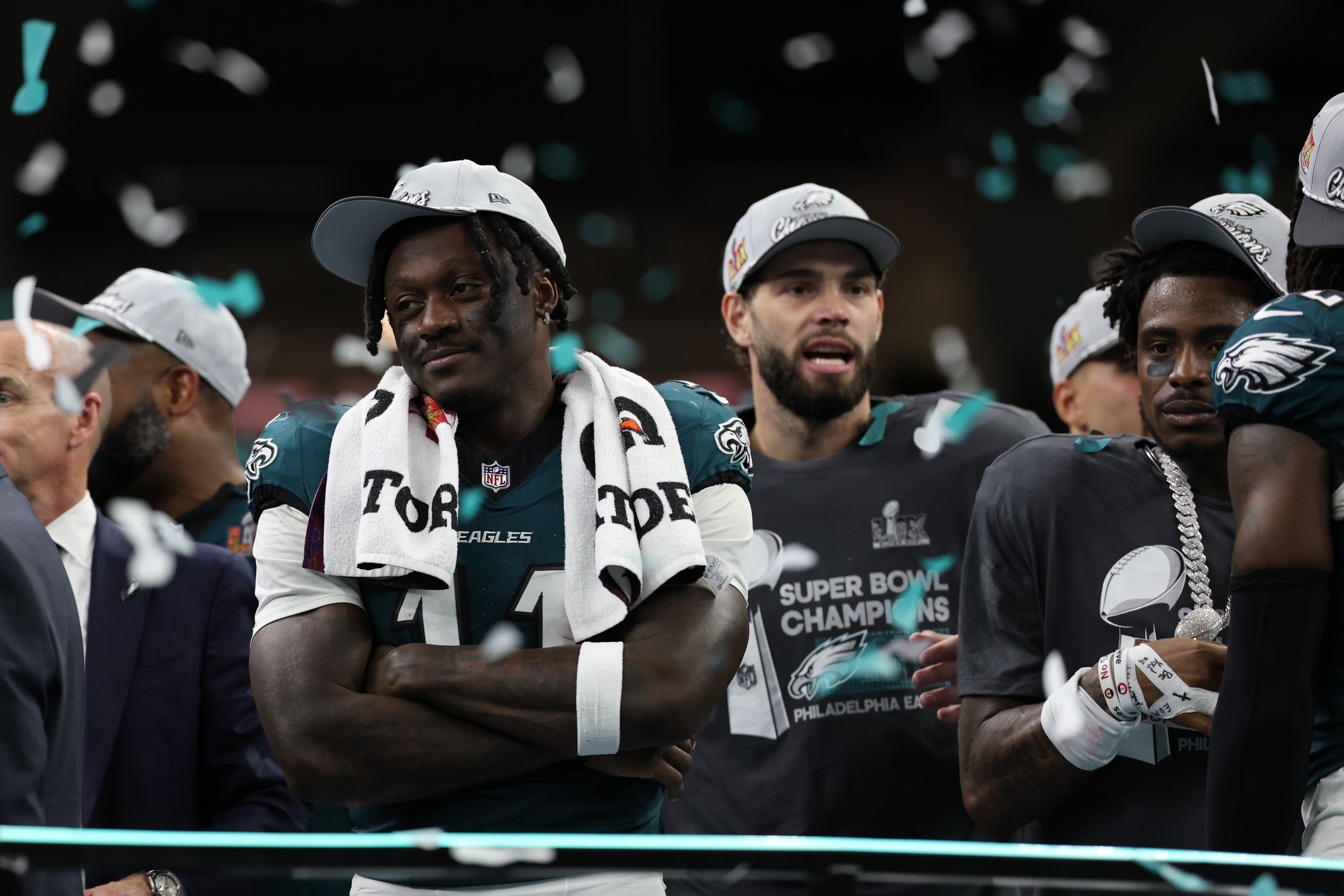 Philadelphia Eagles wide receiver A.J. Brown (L) stands on the stage during the championship trophy presentation after the Eagles' game against the Kansas City Chiefs in Super Bowl LIX at Caesars.