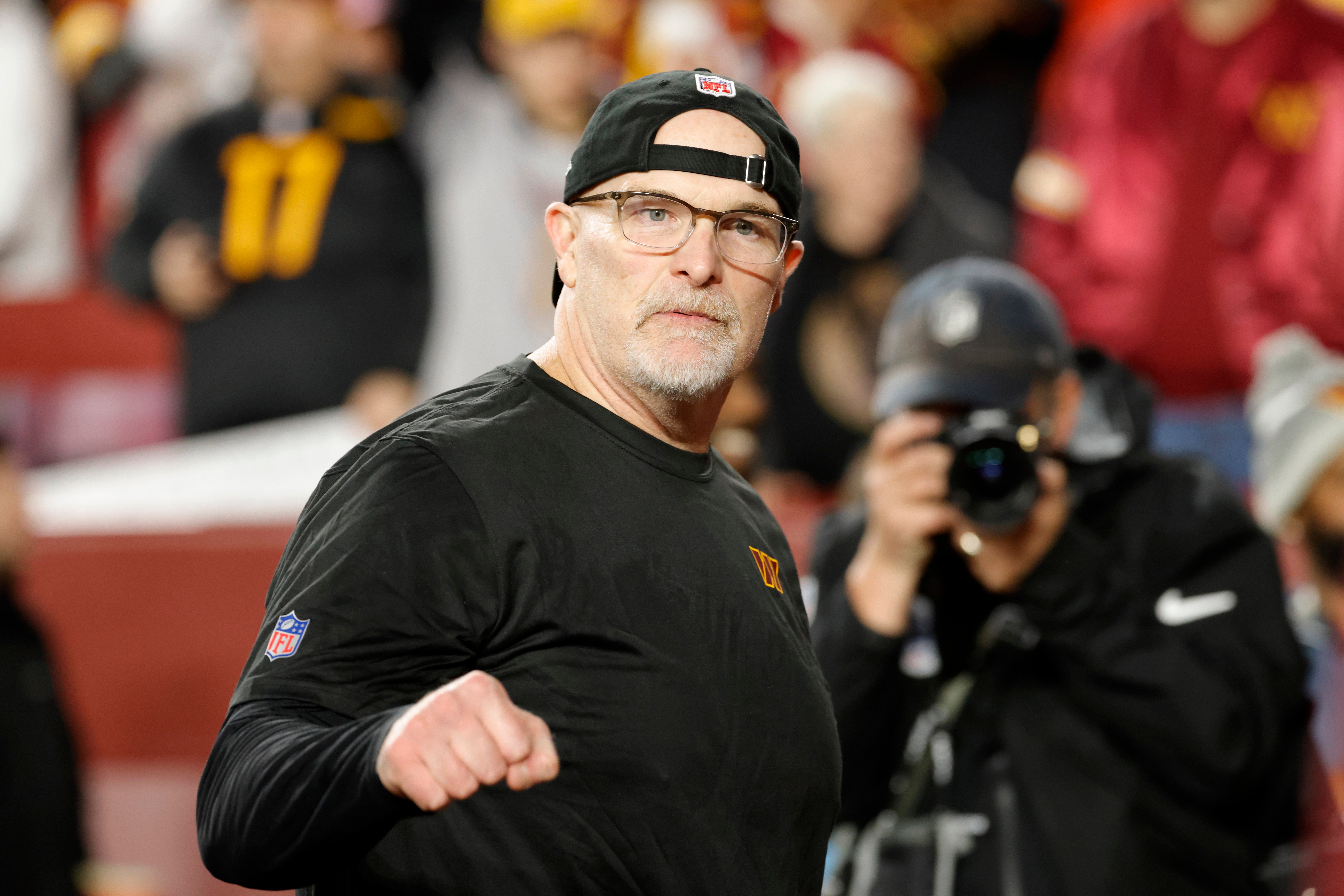 Dec 29, 2024; Landover, Maryland, USA; Washington Commanders head coach Dan Quinn reacts while leaving the field after defeating the Atlanta Falcons at Northwest Stadium.