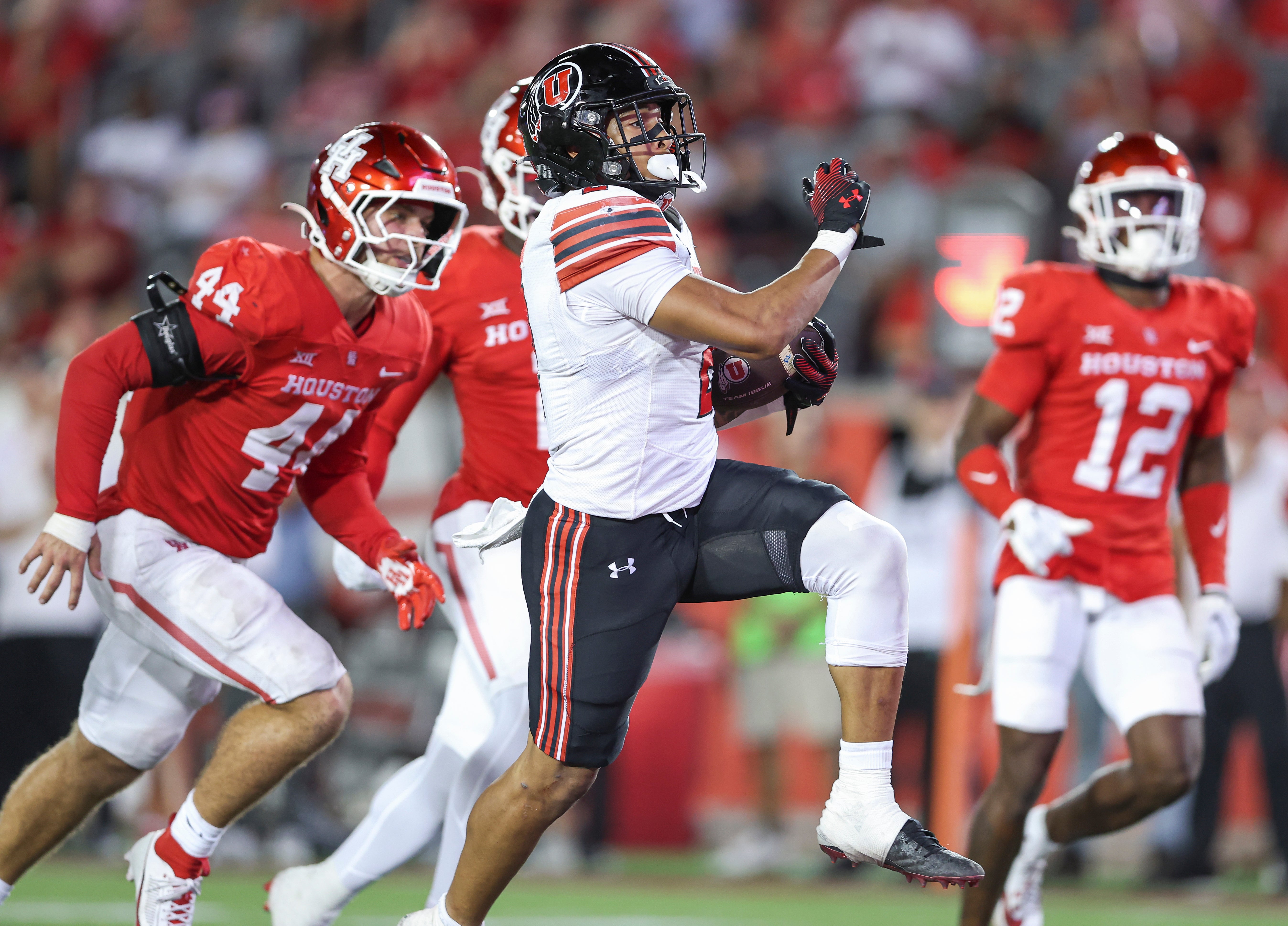 Oct 26, 2024; Houston, Texas, USA; Utah Utes running back Micah Bernard (2) runs with the ball and scores a touchdown during the third quarter against the Houston Cougars at TDECU Stadium.