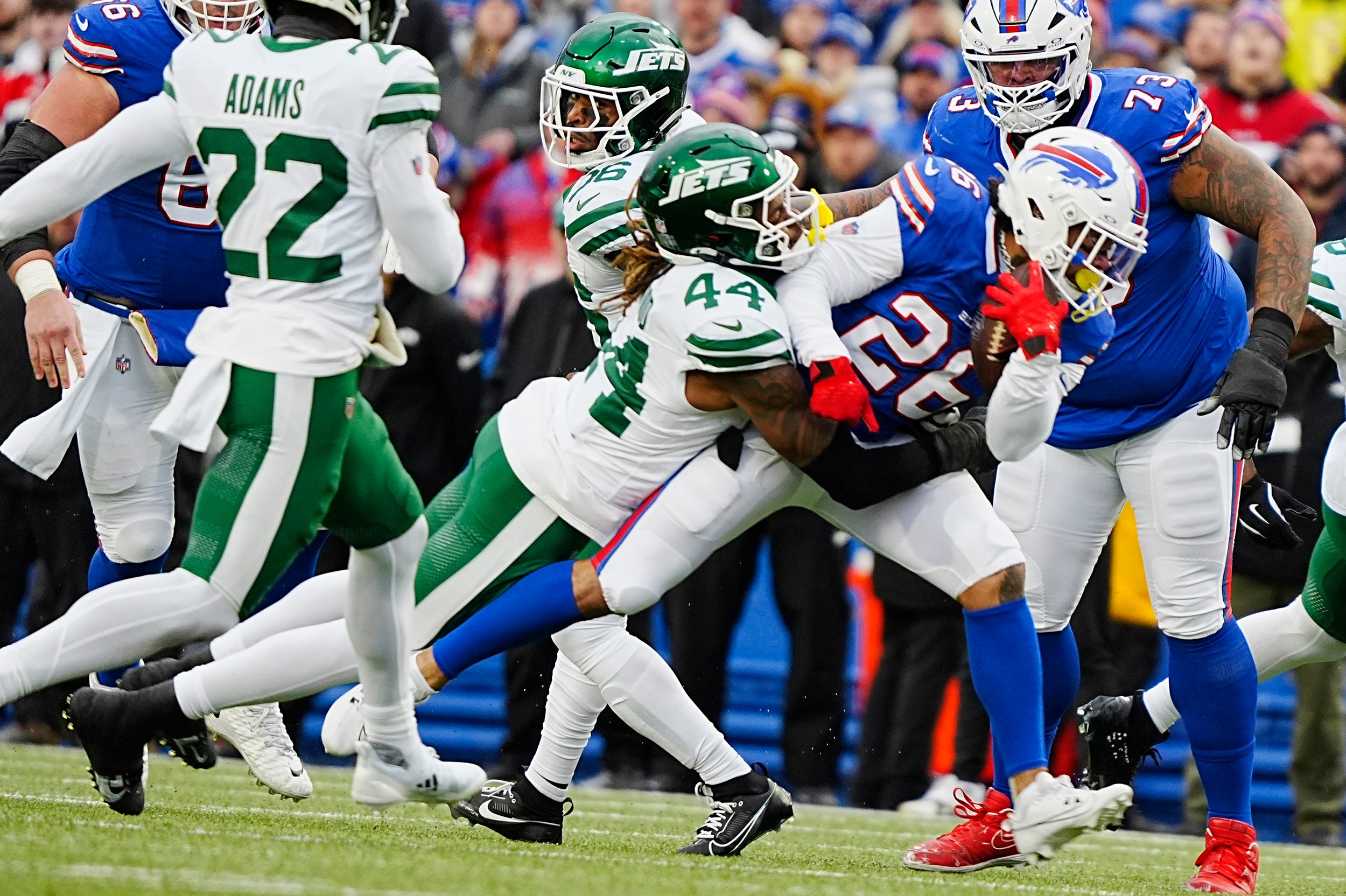 Buffalo Bills running back Ty Johnson (26) gets taken down by New York Jets linebacker Jamien Sherwood (44) during first half action at the Bills home game against the New York Jets at Highmark Stadium in Orchard Park on Dec. 29, 2024. Johnson had gained about five-yards on the play breaking other tackles before Sherwood tackled him.