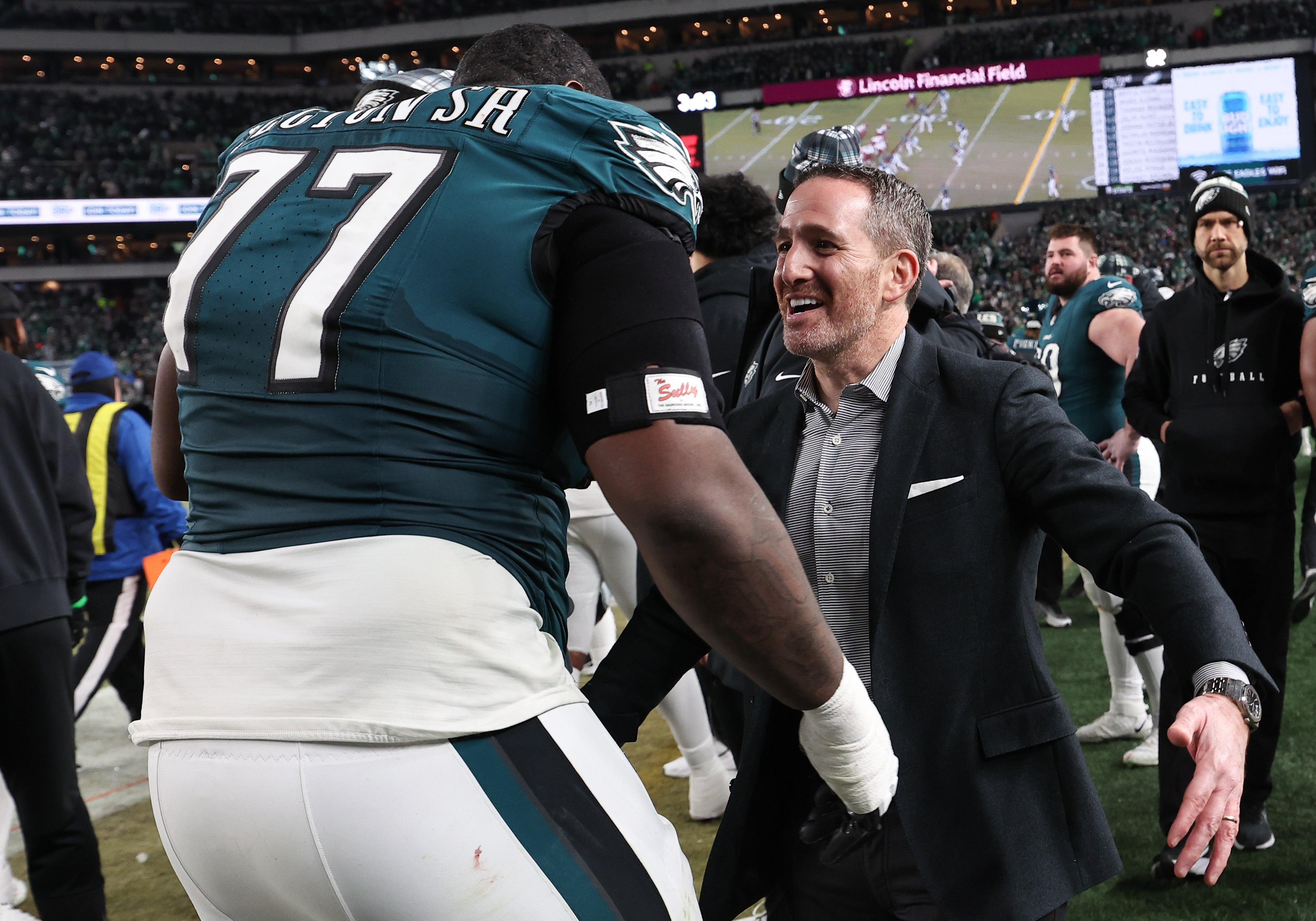 Philadelphia Eagles general manager Howie Roseman celebrates with Philadelphia Eagles offensive tackle Mekhi Becton (77) during the fourth quarter of the NFC Championship game against Washington.