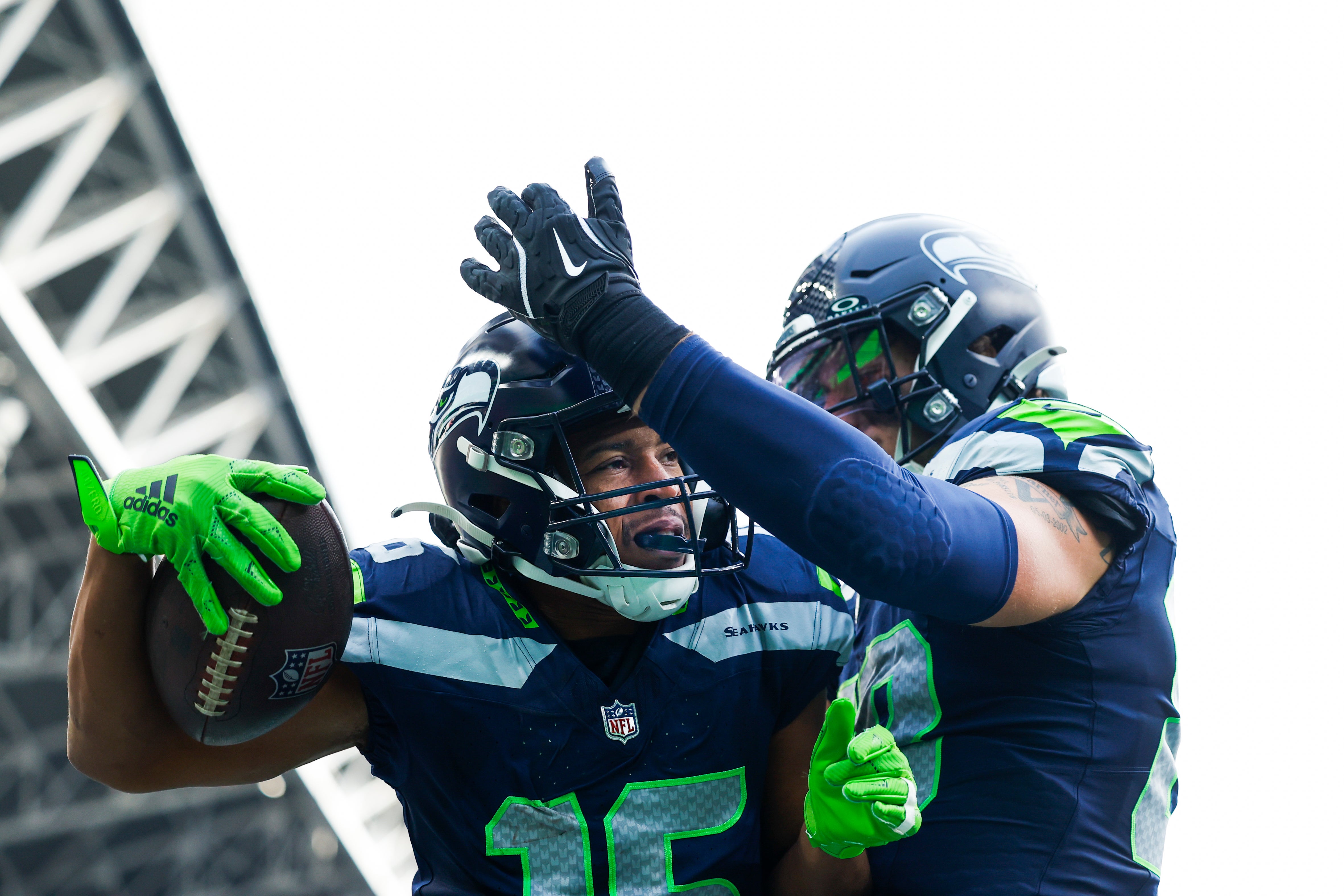 Seahawks wide receiver Tyler Lockett (16) celebrates with tight end AJ Barner (88) after catching a touchdown pass.