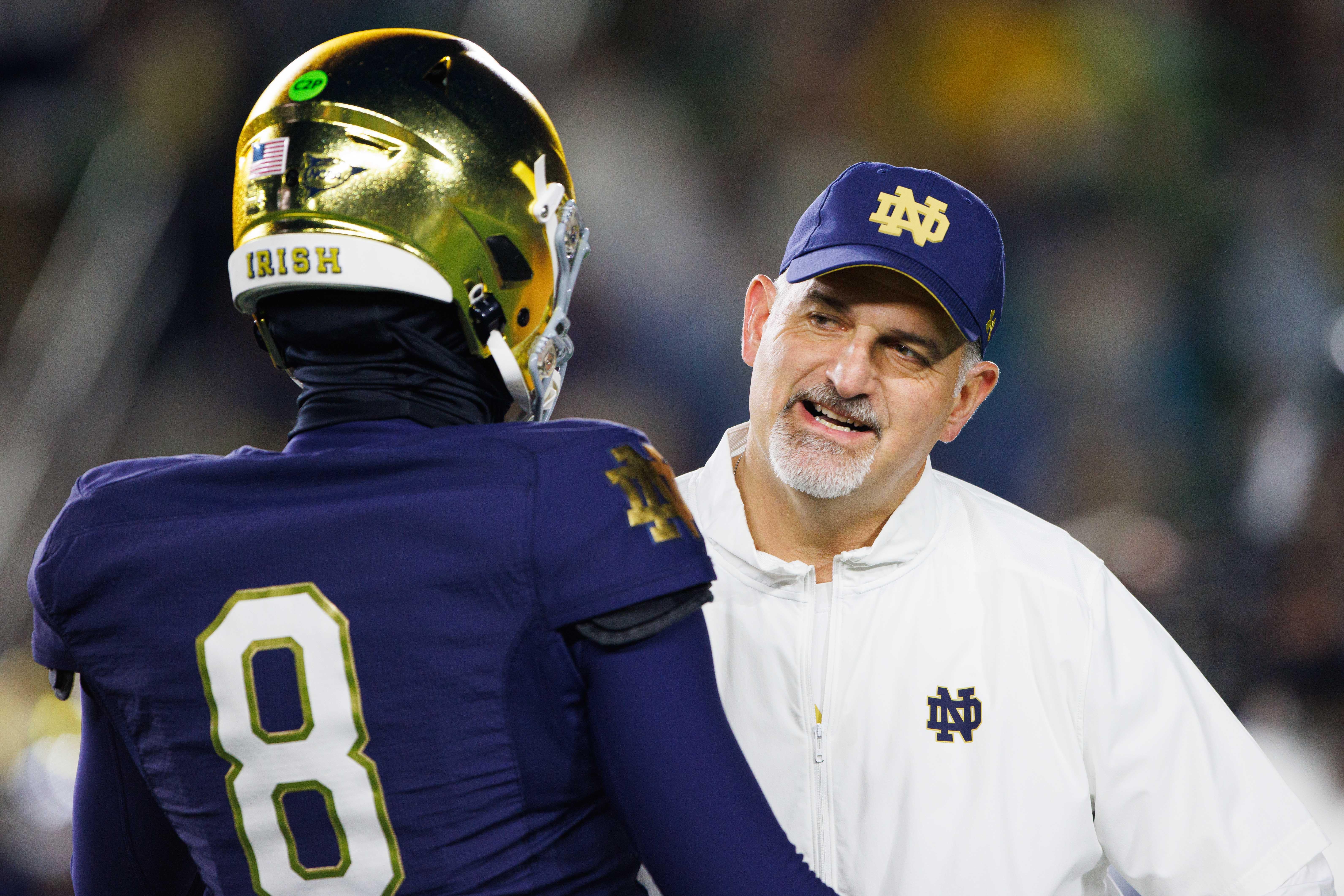 Notre Dame offensive line coach Joe Rudolph speaks with Notre Dame quarterback Kenny Minchey (8) before a NCAA college football game against Florida State at Notre Dame Stadium on Saturday, Nov. 9, 2024, in South Bend.