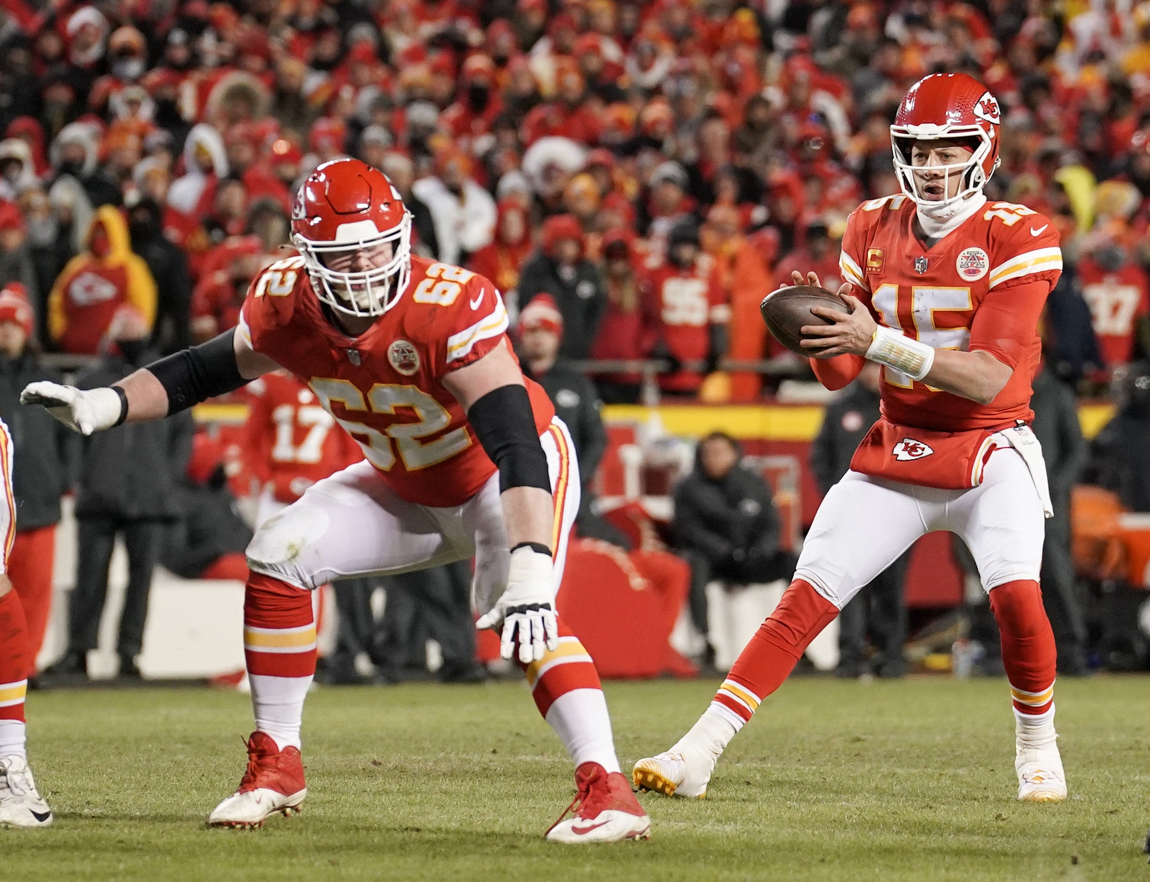Chiefs quarterback Patrick Mahomes (15) drops back to pass as guard Joe Thuney (62) blocks.