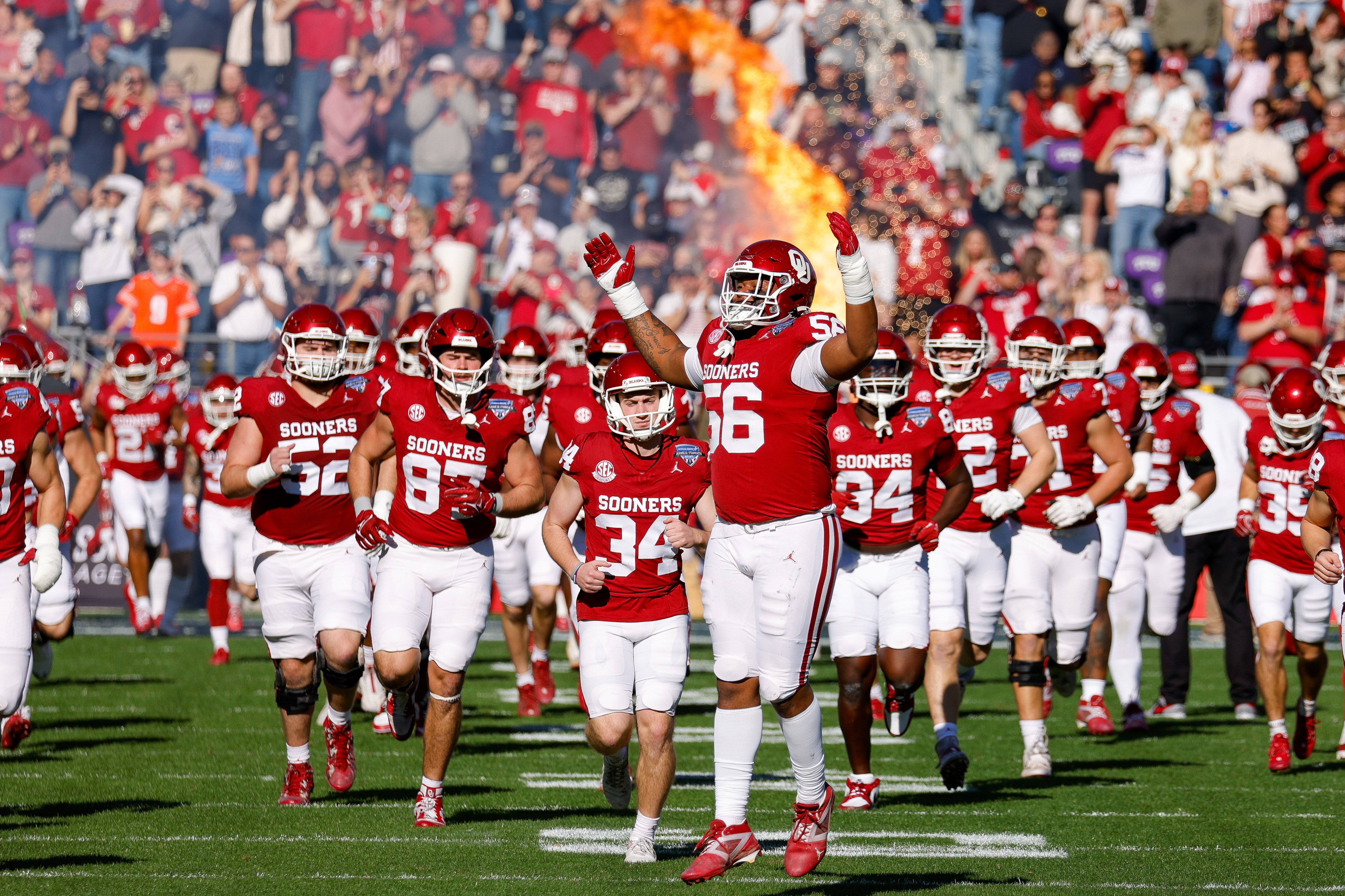 Dec 27, 2024; Fort Worth, TX, USA; The Oklahoma Sooners enter the field prior to the game against the Navy Midshipmen at Amon G. Carter Stadium. 