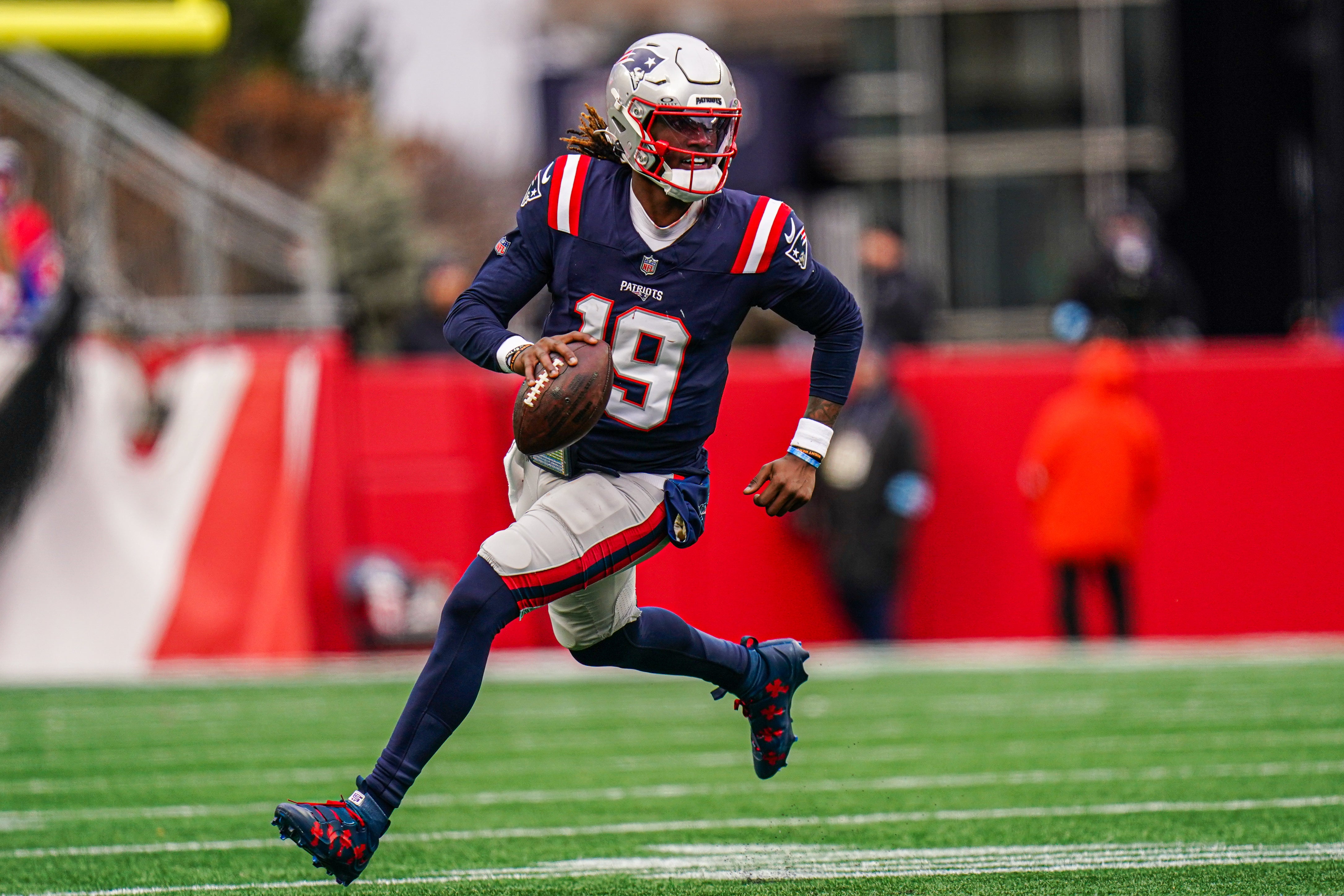 Jan 5, 2025; Foxborough, Massachusetts, USA; New England Patriots quarterback Joe Milton III (19) runs the ball against the Buffalo Bills in the first half at Gillette Stadium.