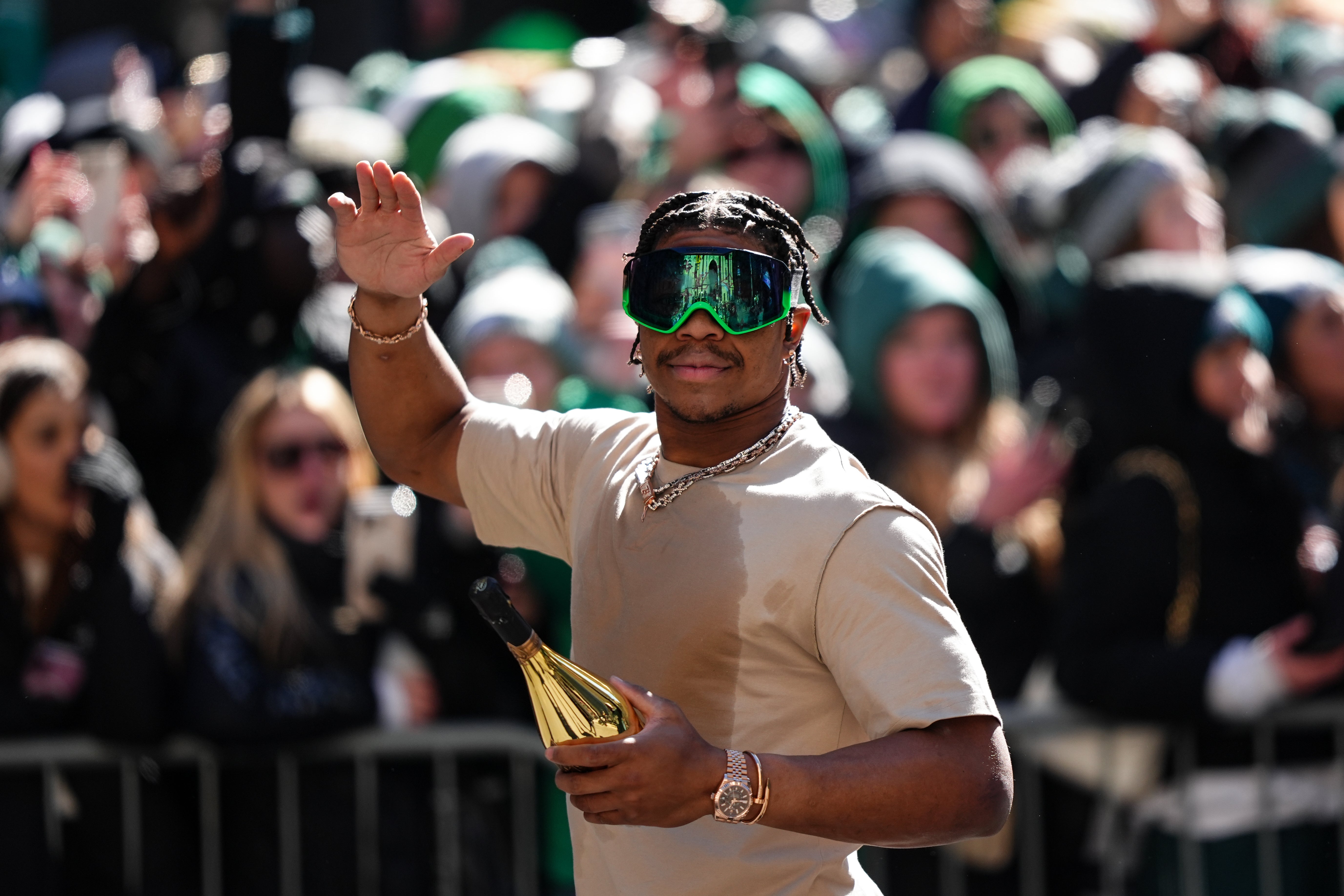Nolan Smith Jr waves to fans during the Super Bowl LIX championship parade and rally.