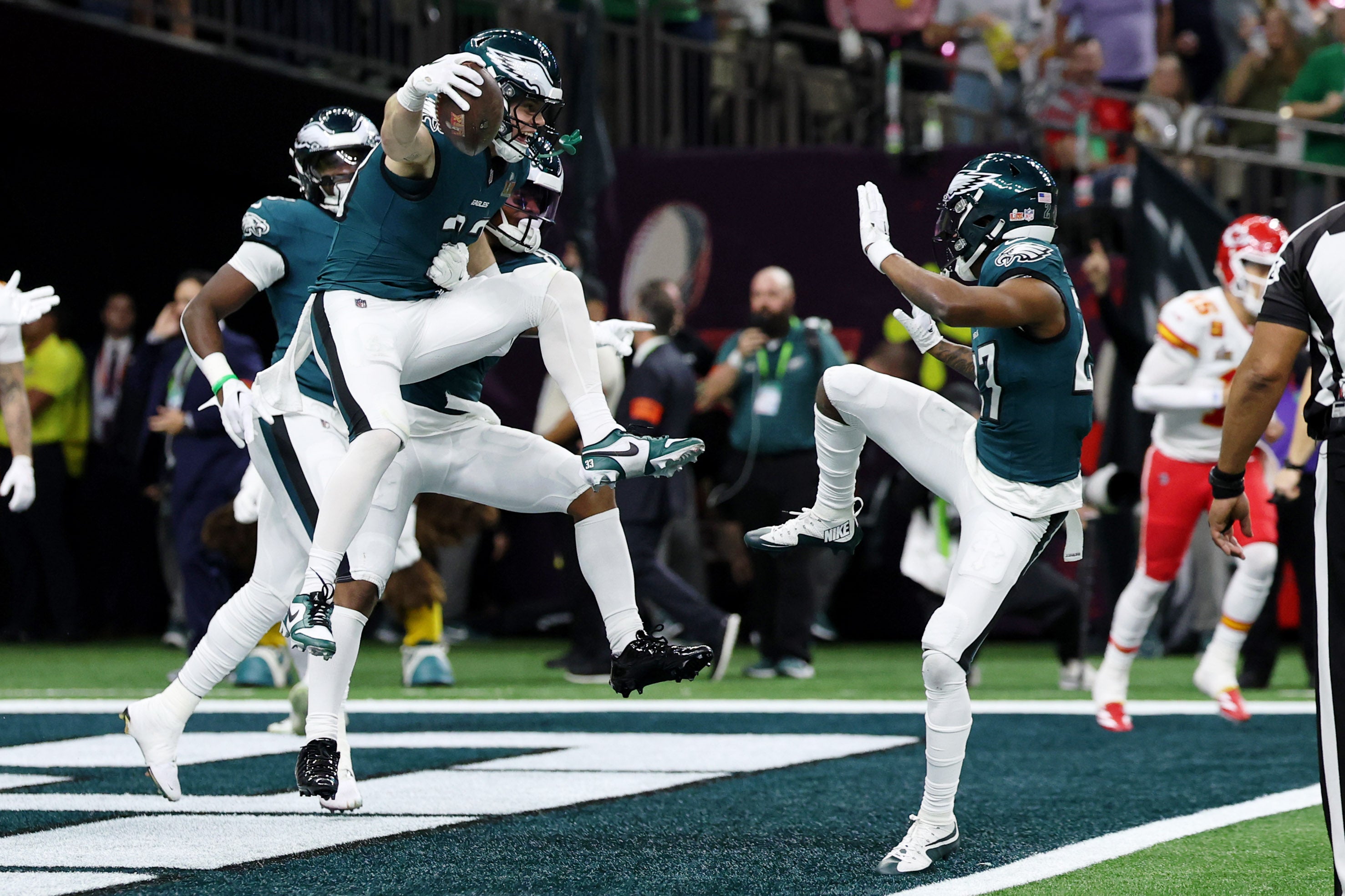 Philadelphia Eagles cornerback Cooper DeJean (33) celebrates with teammates after returning an interception for a touchdown against the Kansas City Chiefs during the first half of Super Bowl LIX.