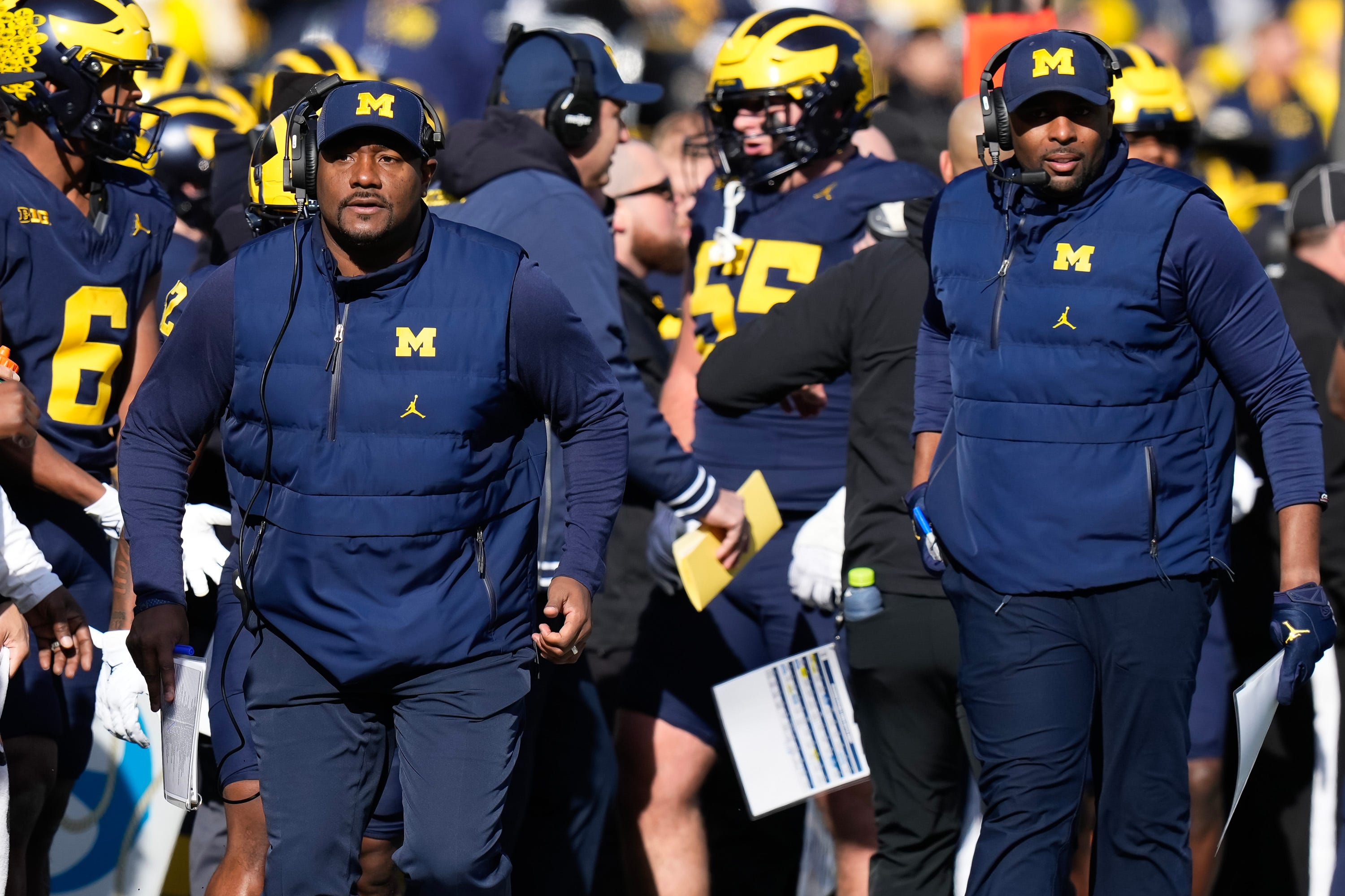 Nov 25, 2023; Ann Arbor, Michigan, USA; Michigan Wolverines wide receivers coach Ron Bellamy and interim head coach Sherrone Moore run up the sideline during the NCAA football game against the Ohio State Buckeyes at Michigan Stadium.