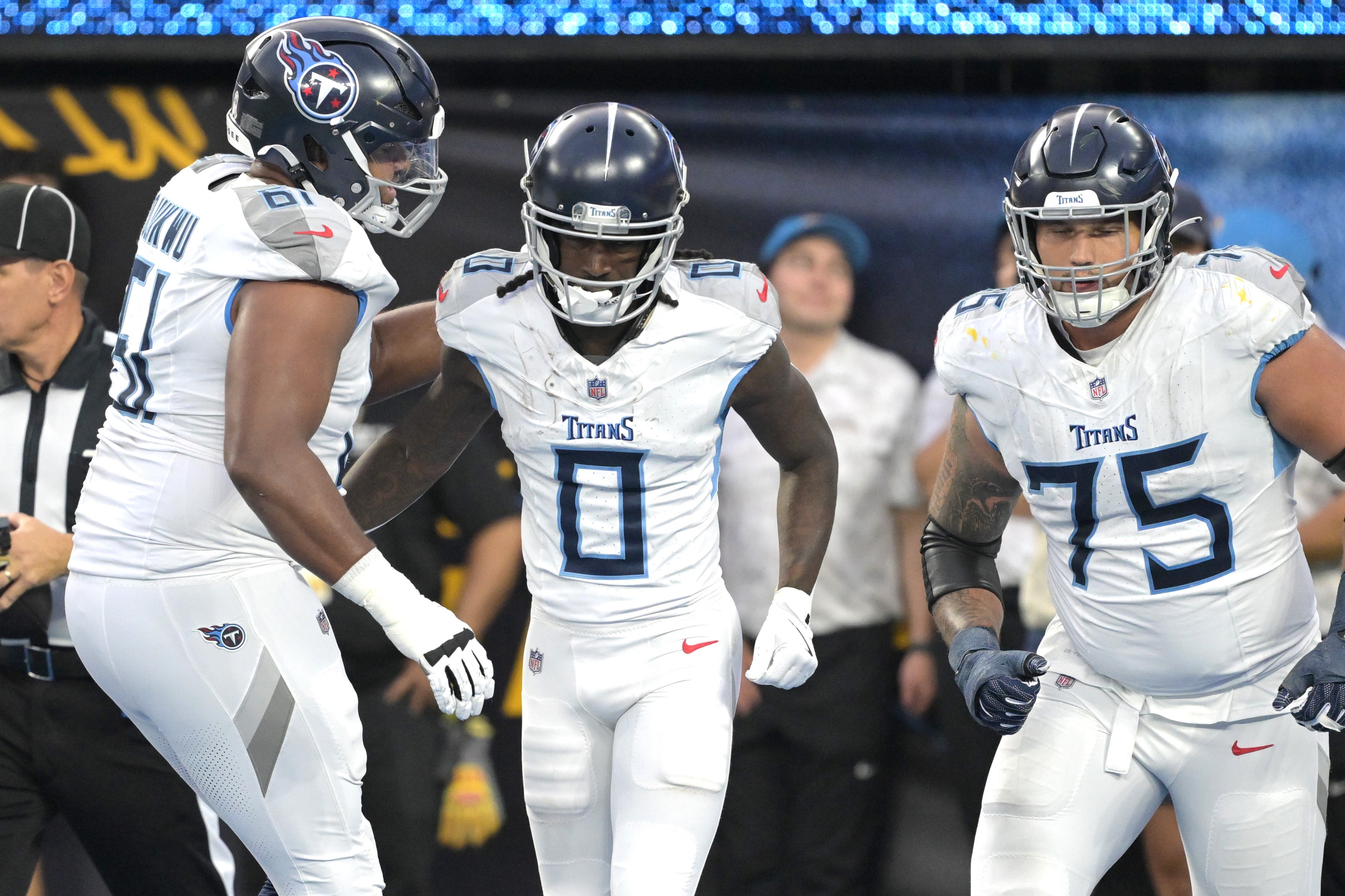 Nov 10, 2024; Inglewood, California, USA; Tennessee Titans wide receiver Calvin Ridley (0) is congratulated by offensive tackle John Ojukwu (61) and offensive tackle Dillon Radunz (75) after a touchdown in the second half against the Los Angeles Chargers at SoFi Stadium. Mandatory Credit: Jayne Kamin-Oncea-Imagn Images