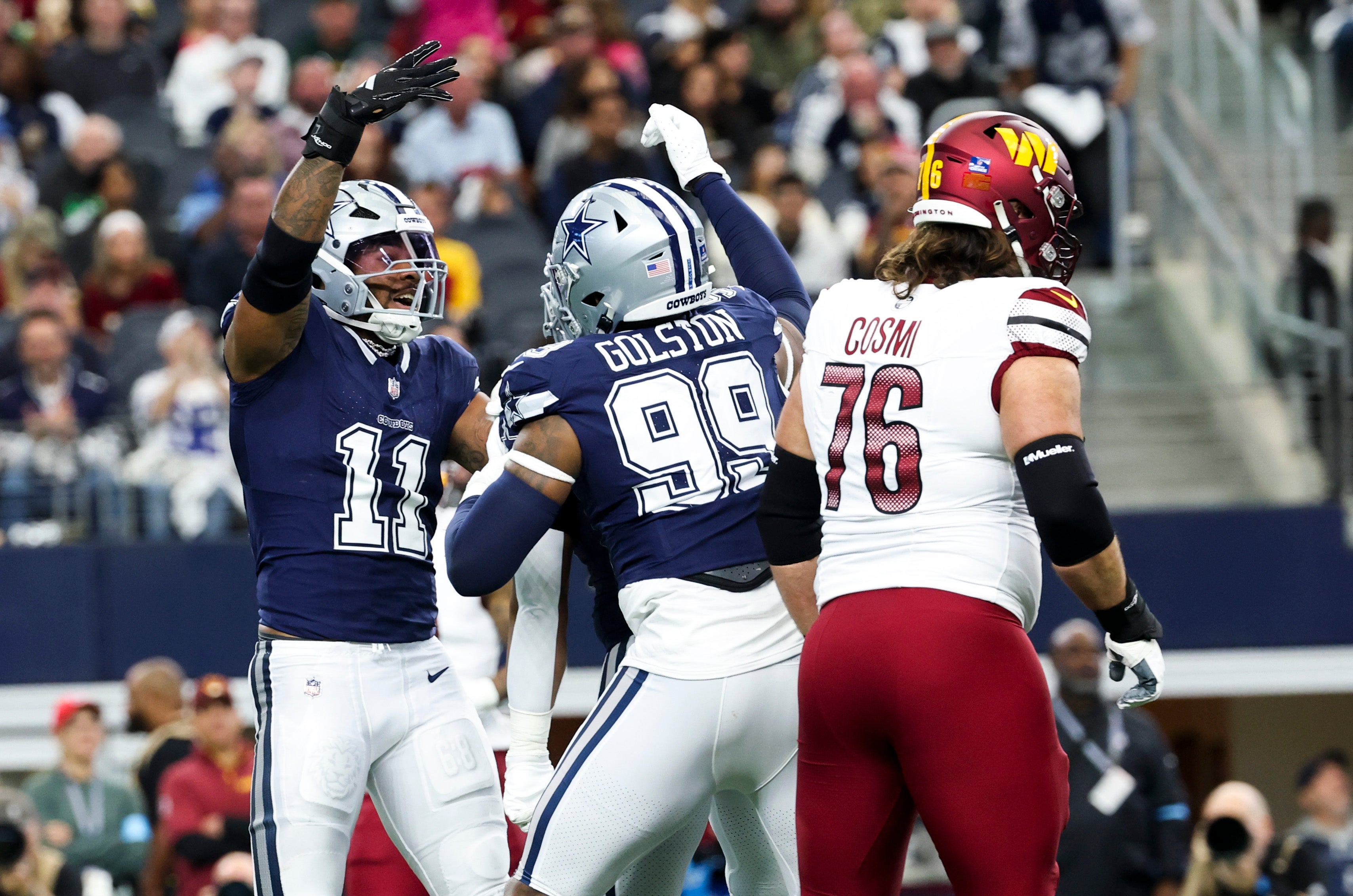 Jan 5, 2025; Arlington, Texas, USA; Dallas Cowboys linebacker Micah Parsons (11) celebrates with Dallas Cowboys defensive end Chauncey Golston (99) in front of Washington Commanders guard Sam Cosmi (76) after a sack during the first quarter at AT&T Stadium.