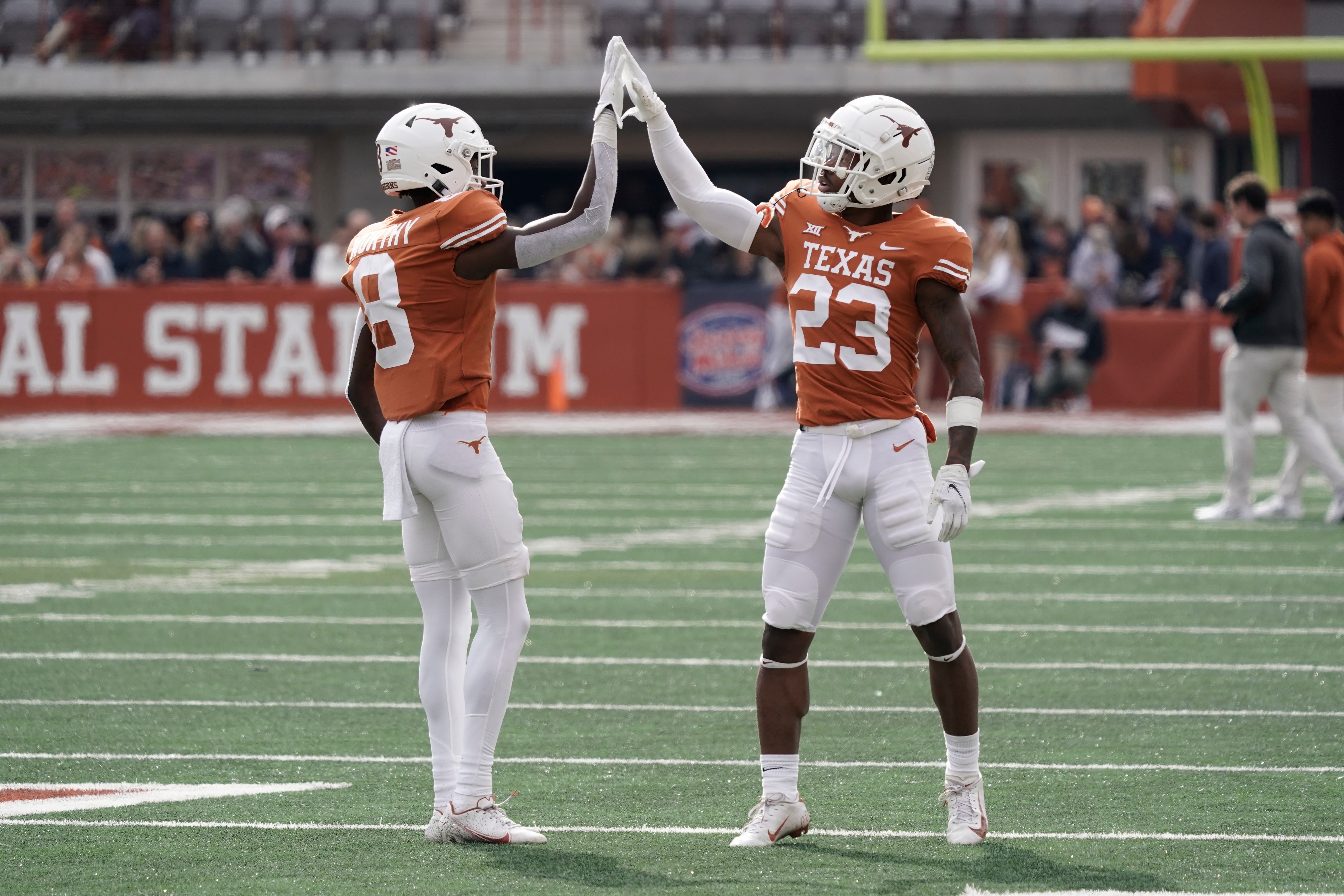 Nov 26, 2021; Austin, Texas, USA; Texas Longhorns wide receiver Xavier Worthy (8) and defensive back Jahdae Barron (23) before the game against the Kansas State Wildcats at Darrell K Royal-Texas Memorial Stadium.
