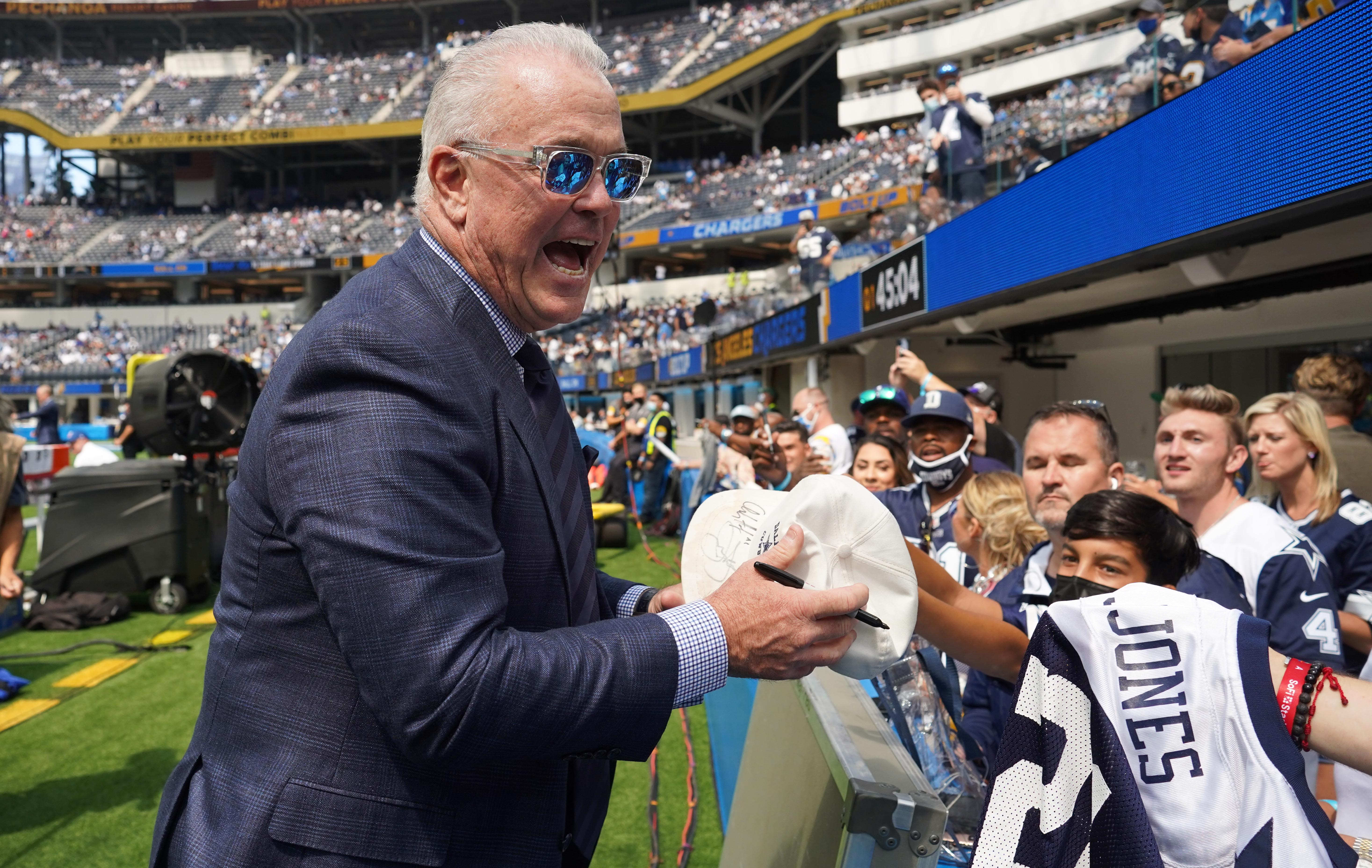 Dallas Cowboys executive vice president Stephen Jones signs autographs before the game against the Los Angeles Chargers at SoFi Stadium.