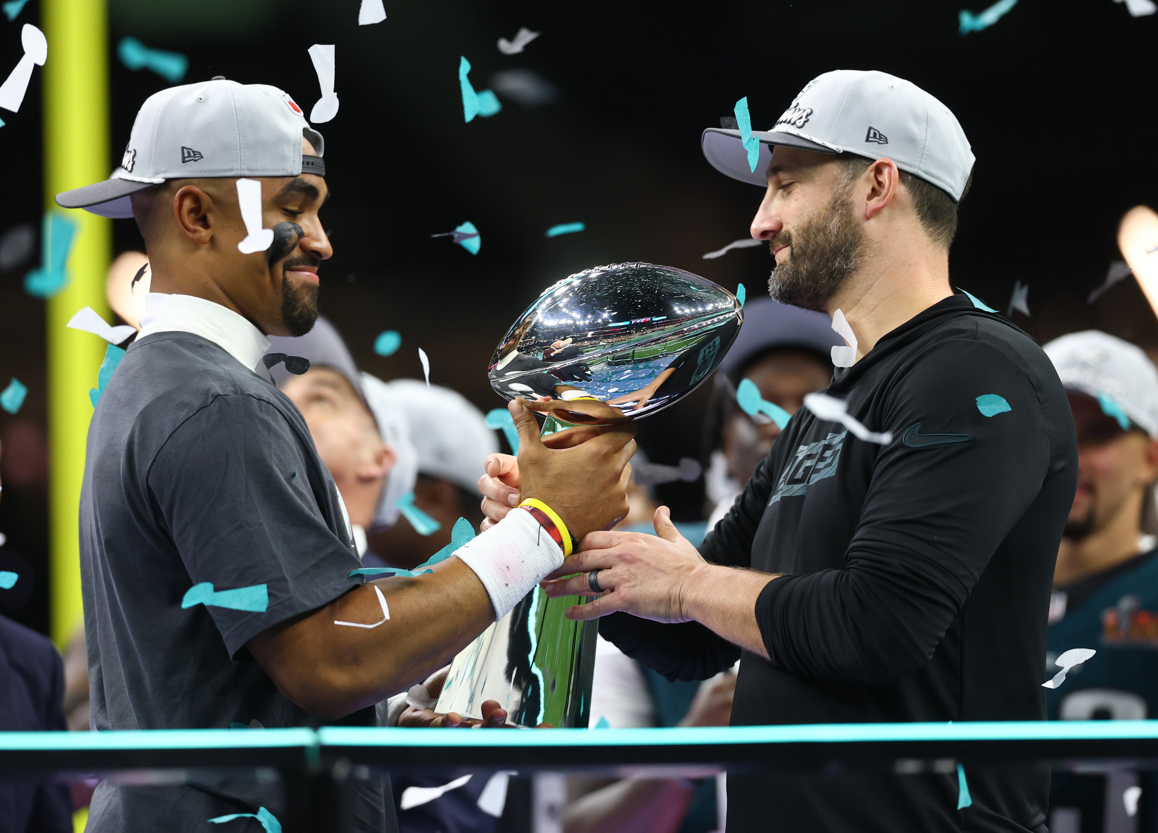 Philadelphia Eagles quarterback Jalen Hurts (1) passes the Vince Lombardi Trophy to Philadelphia Eagles head coach Nick Sirianni after defeating the Kansas City Chiefs in Super Bowl LIX at Ceasars.
